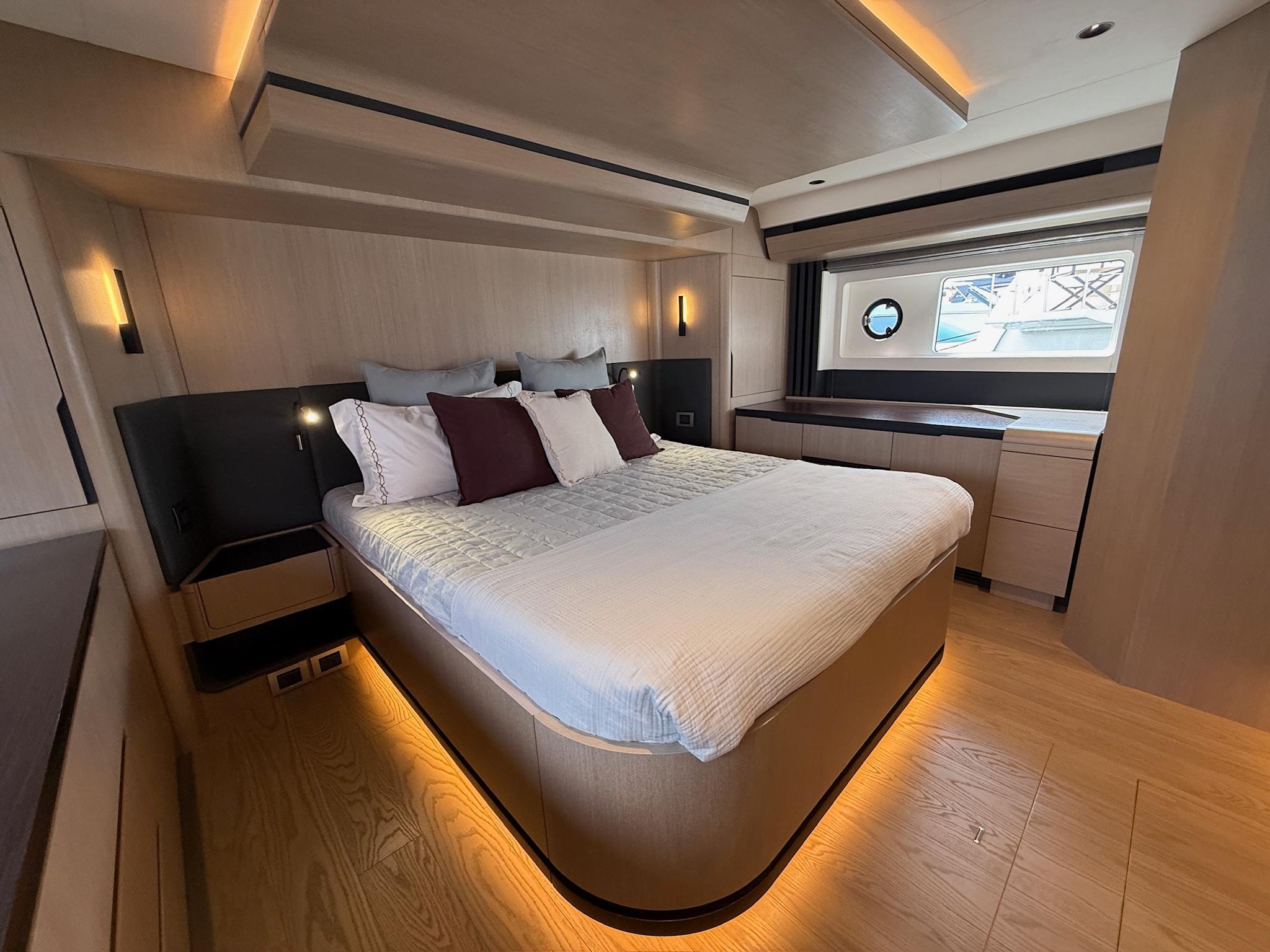 Luxurious bedroom interior of 2025 Sirena 48 Coupe yacht with modern design and ambient lighting.