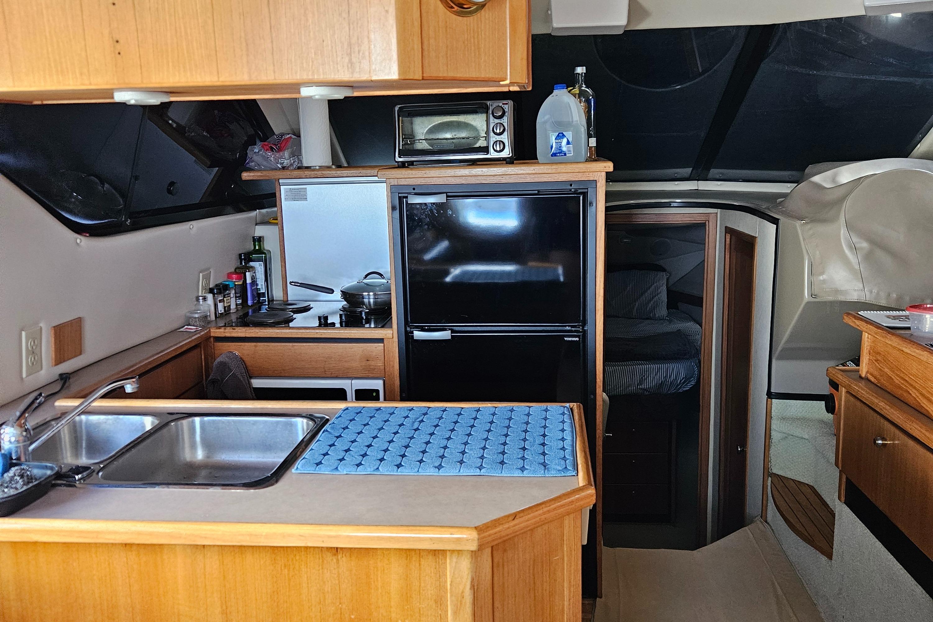 1997 Bayliner 3788 Command Bridge Motoryacht interior with kitchen and sleeping area.