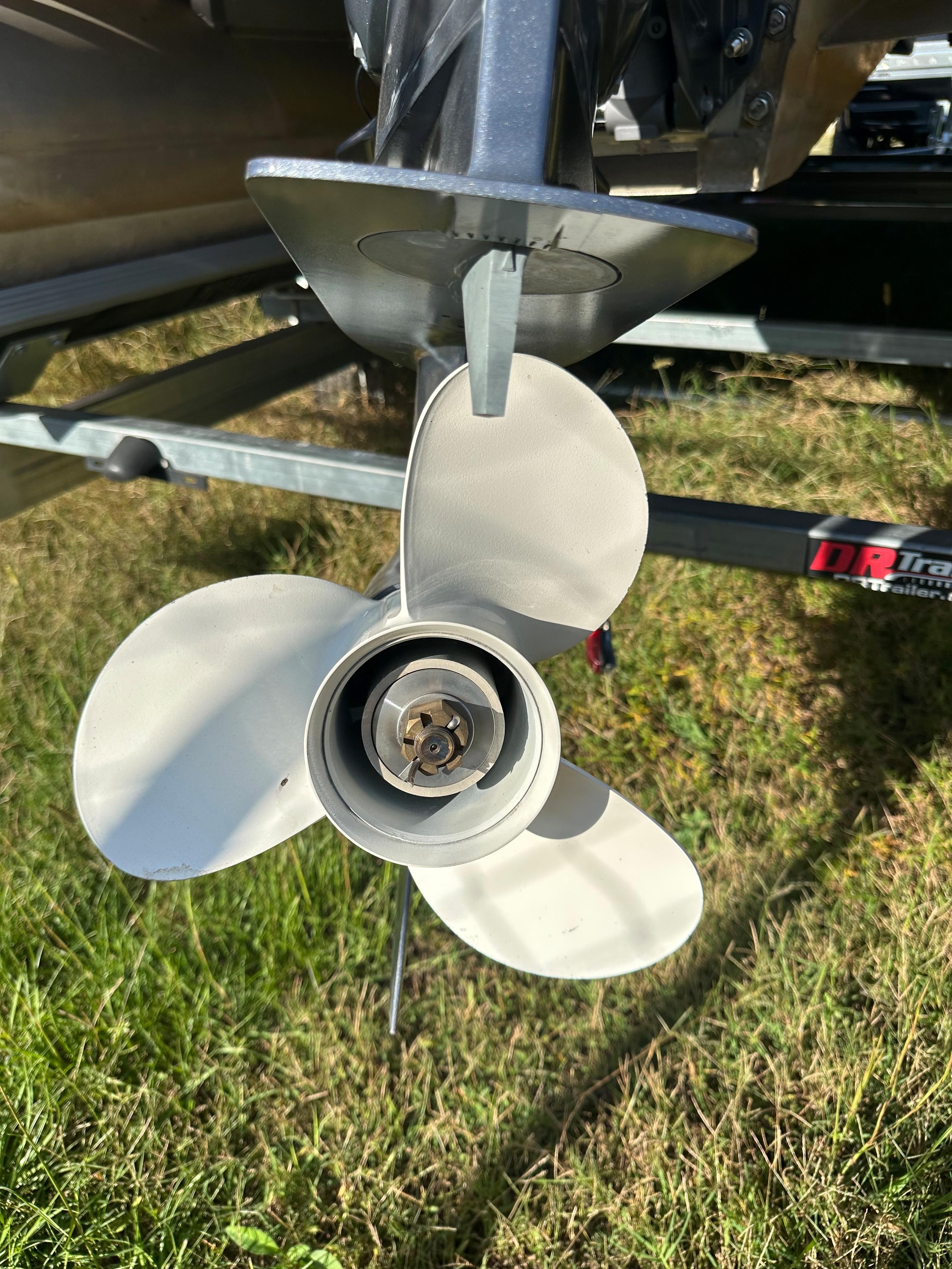 Close-up of a 2022 Crest Pontoon propeller on grass.