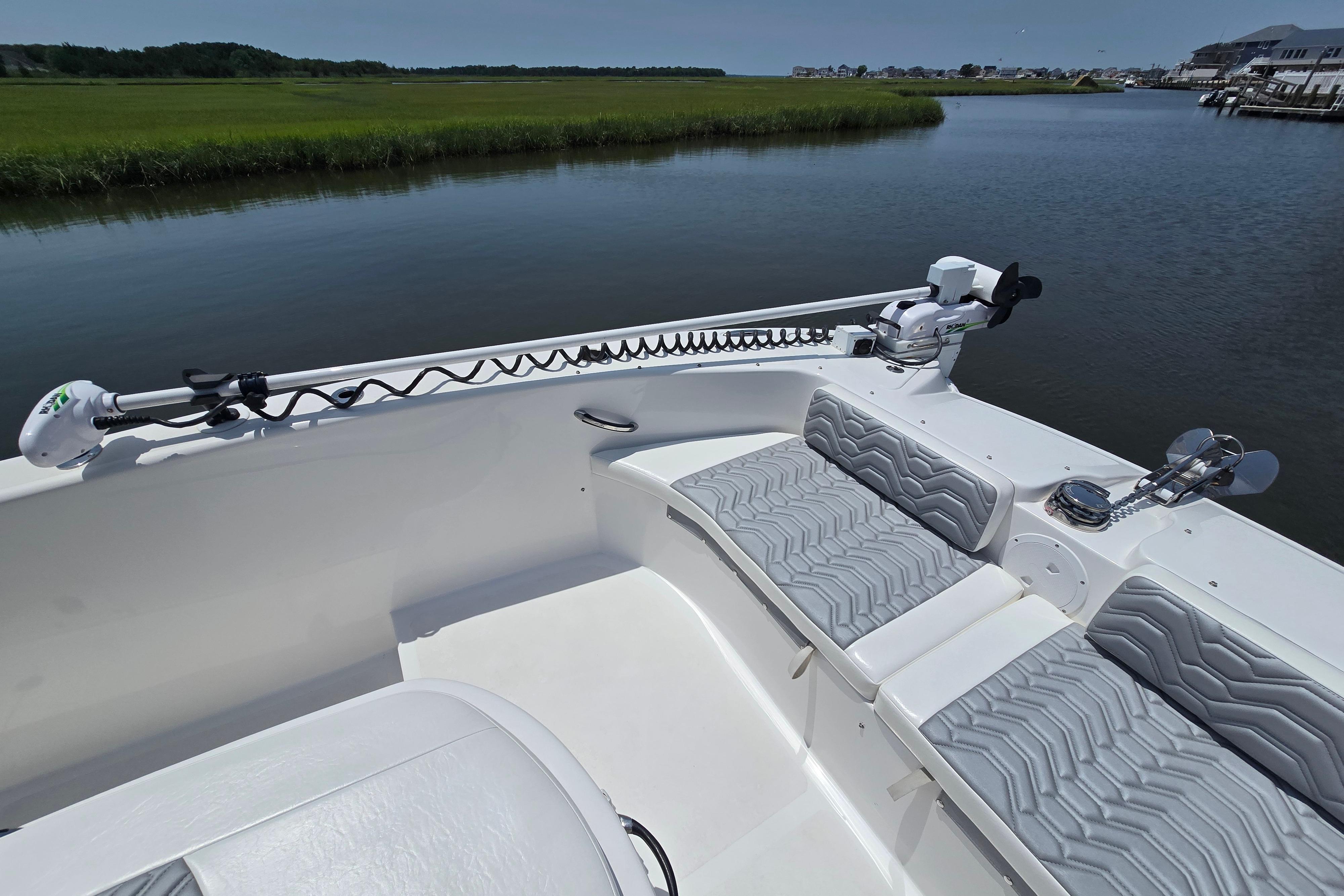 2021 Twin Vee 280 GFX CC boat interior with seating and trolling motor on calm water.