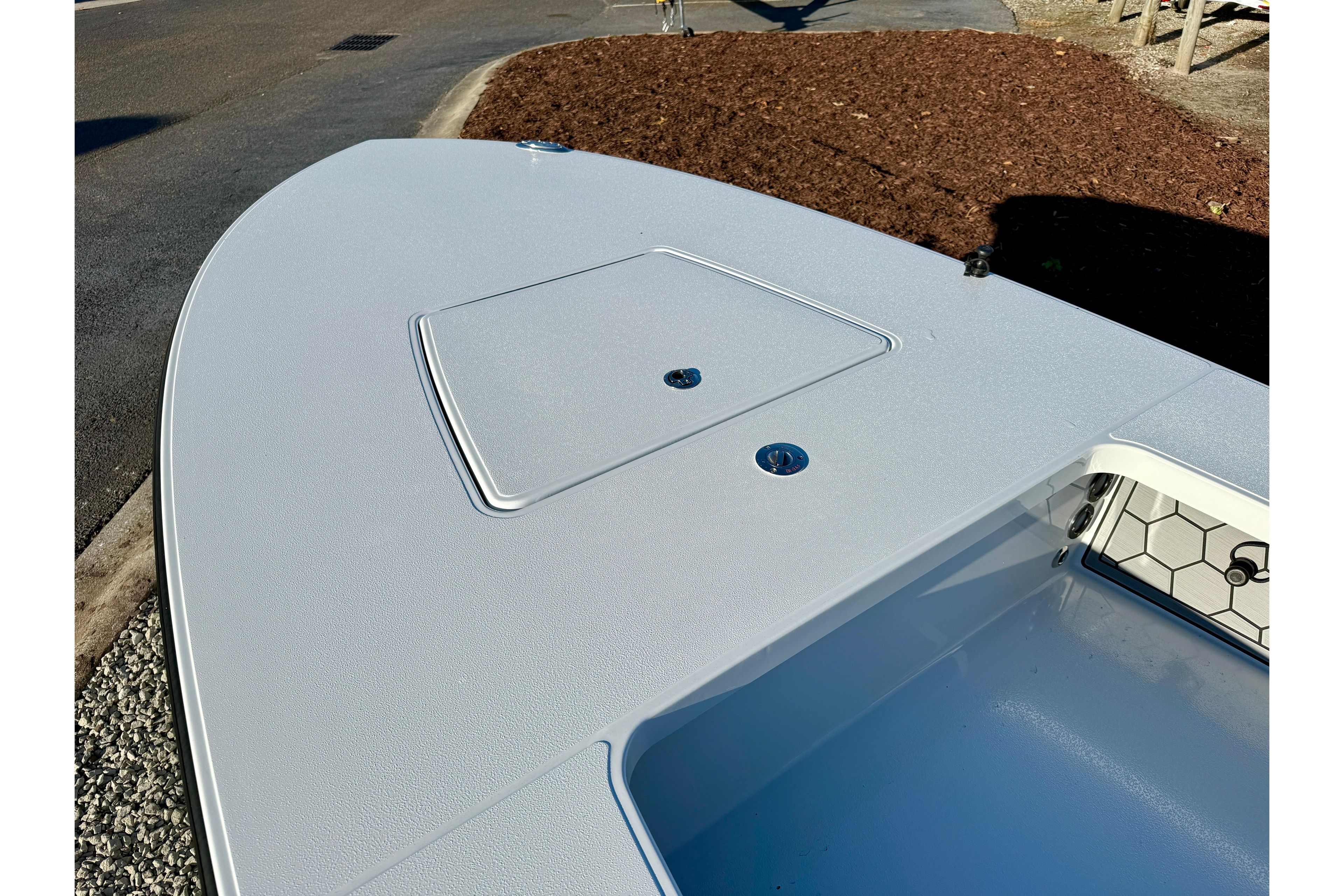 2026 East Cape EVO 17V boat deck with storage hatch, sleek design.