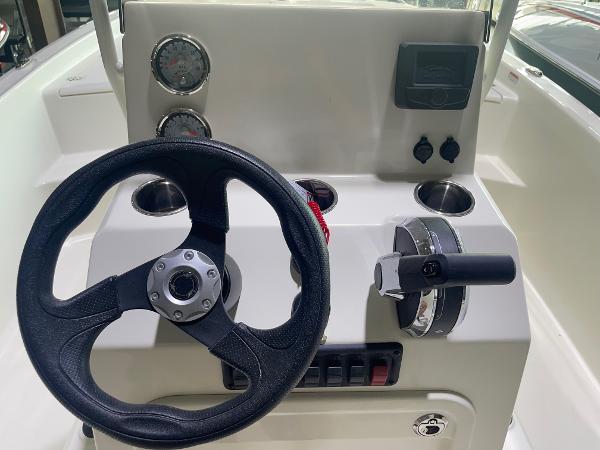 2024 Mako Pro Skiff 19 CC center console with steering wheel and controls.