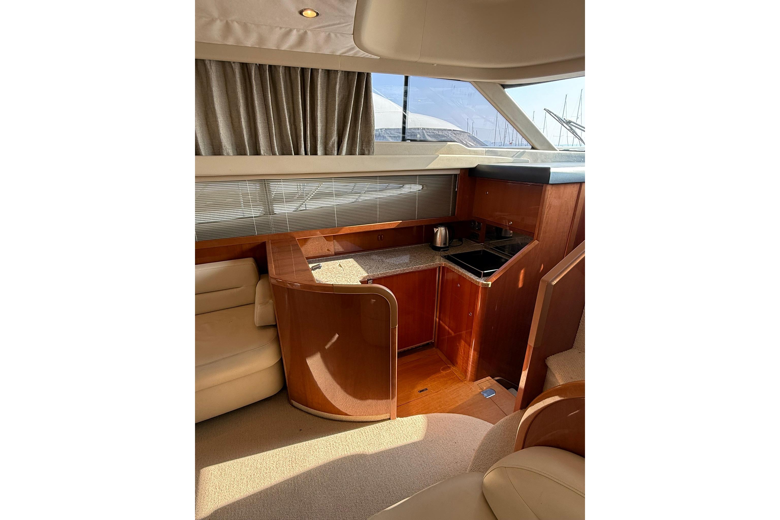 Luxurious interior of a 2007 Princess 50 yacht with kitchenette and seating area.