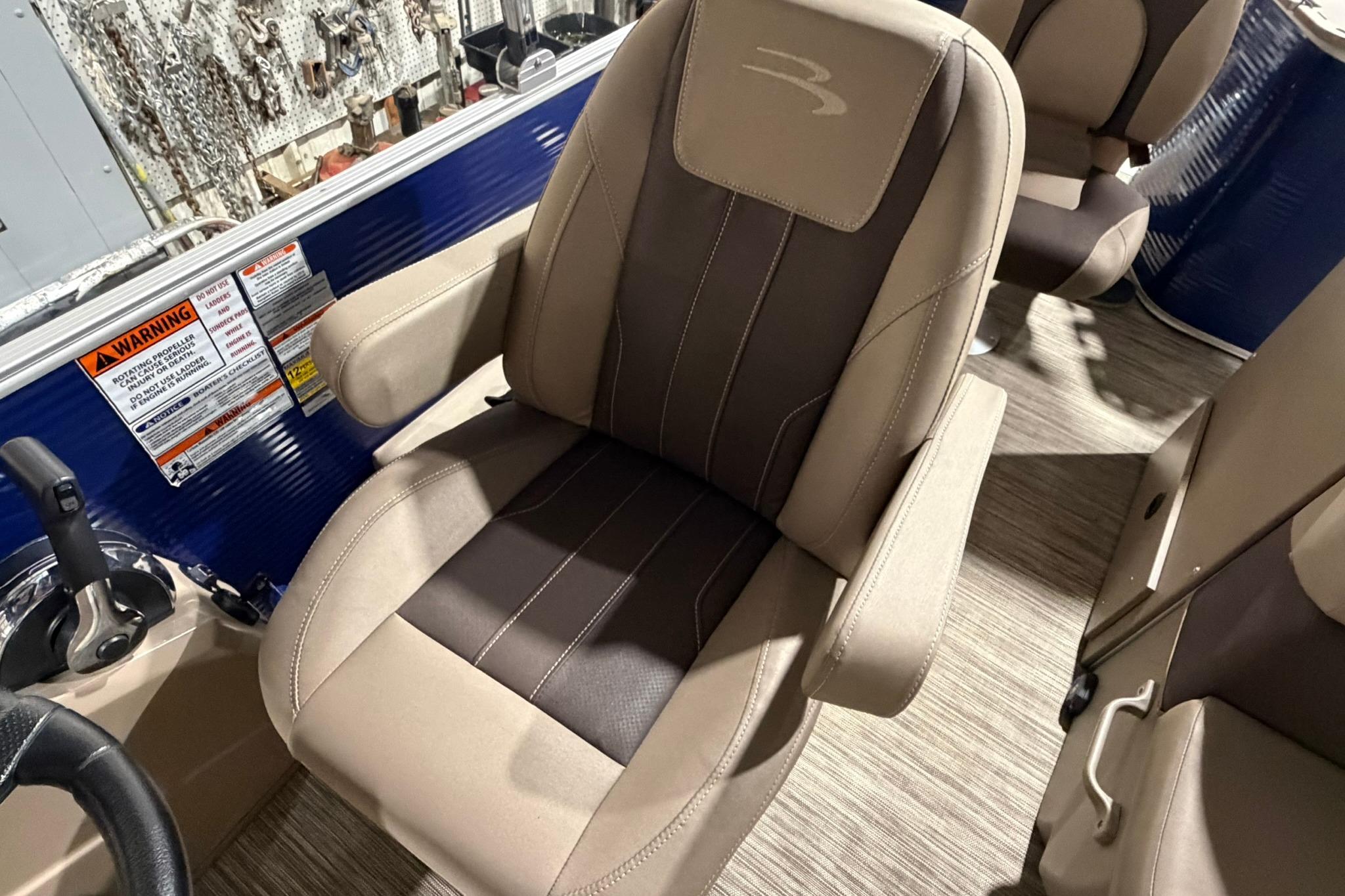 Captain's chair on 2020 Bennington SX 22 SFX pontoon boat, featuring beige and brown upholstery.