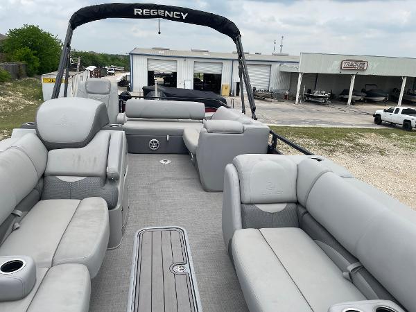 2023 Regency 250DL3 pontoon boat with spacious seating and modern design.