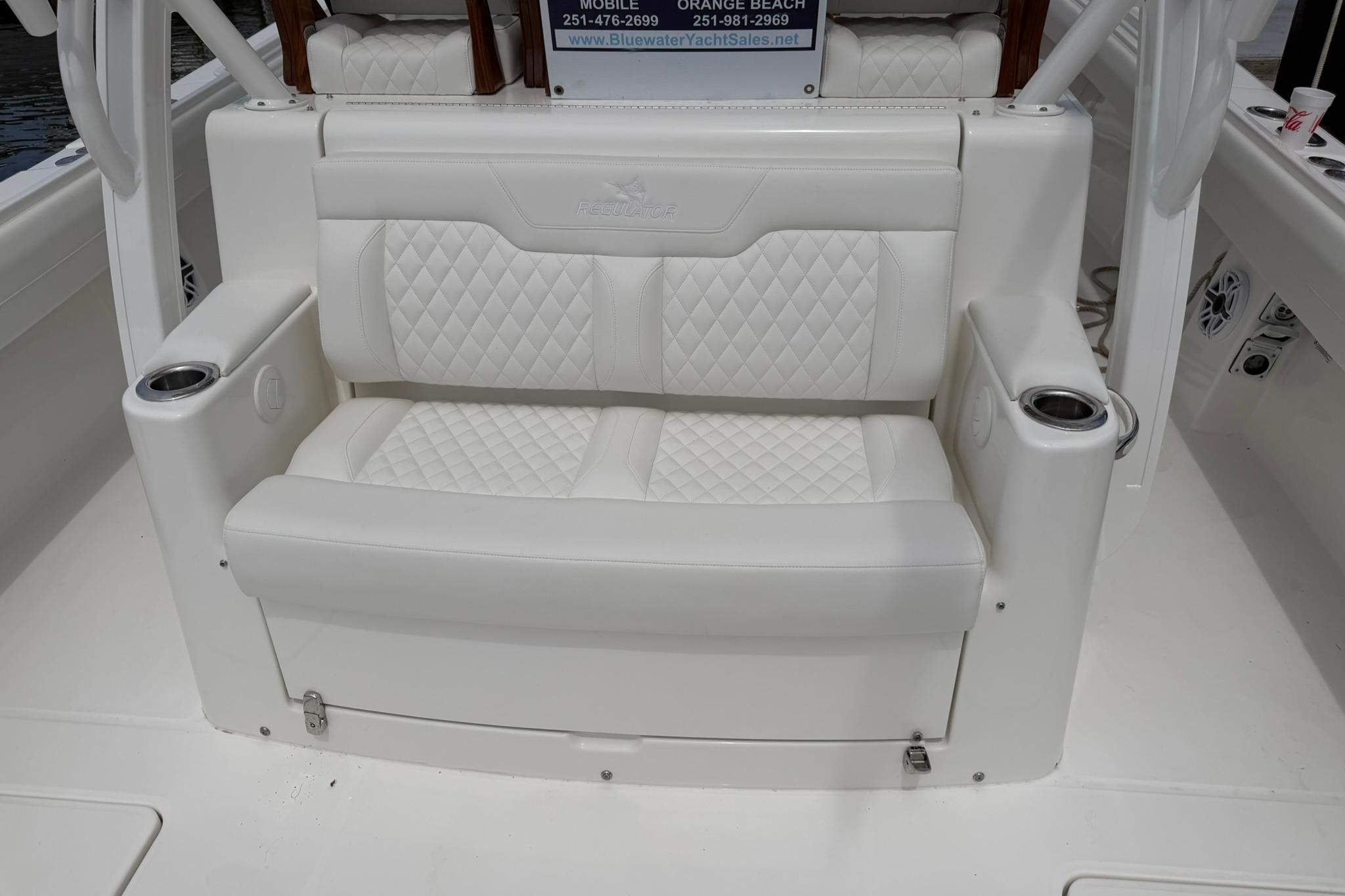 Luxurious white seating on 2026 Regulator 37 boat with cup holders and quilted design.