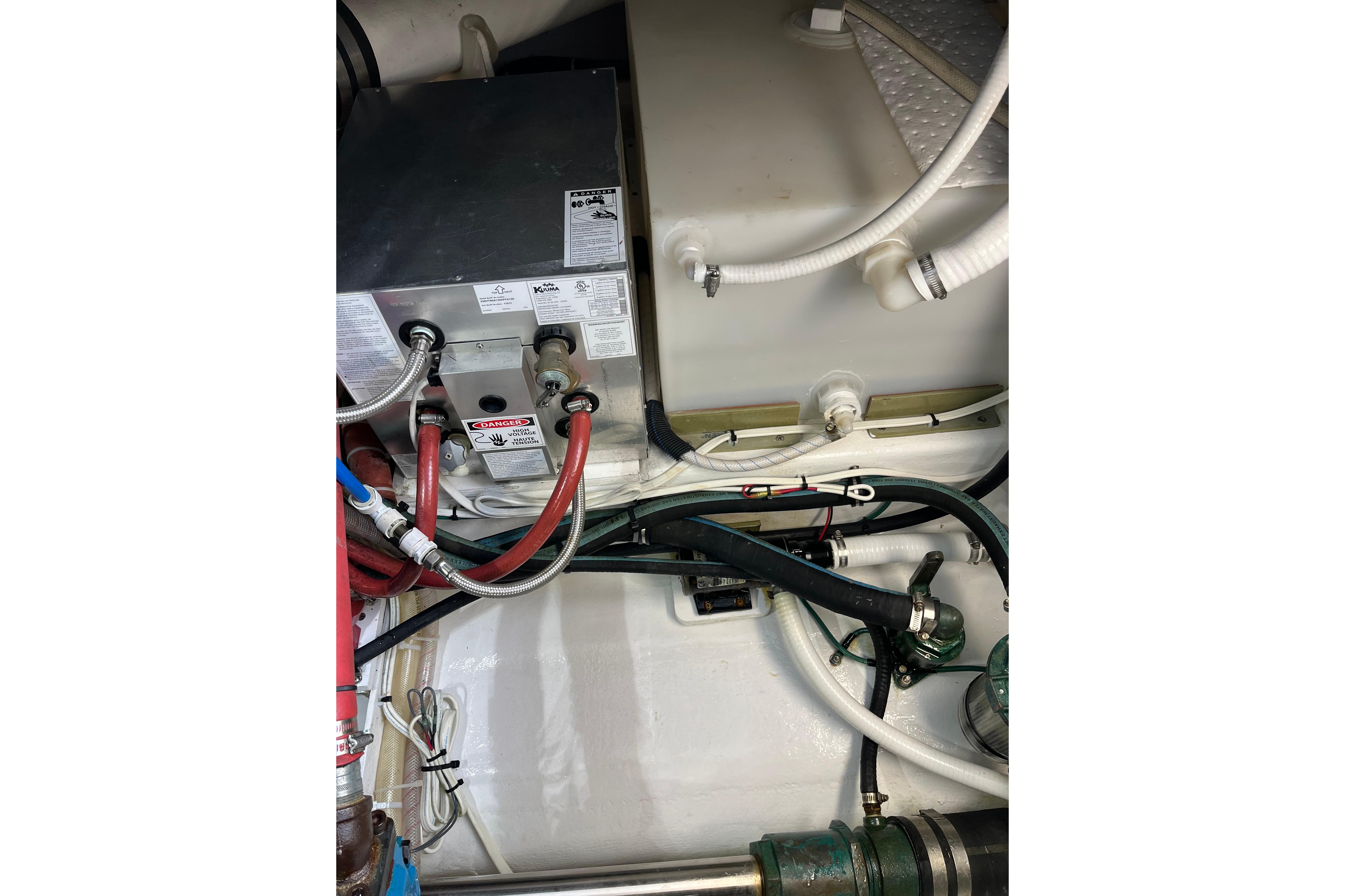 Engine compartment of a 2018 H&H Marine Osmond Beal boat, showing various hoses and components.