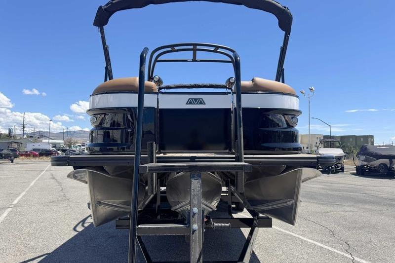 2026 Avalon Excalibur LTD Quad Lounge pontoon boat, rear view in a parking lot.