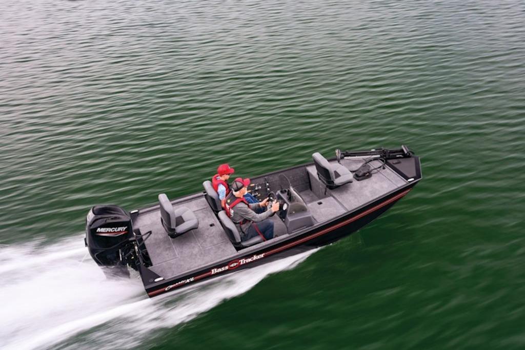 2026 Tracker Bass Tracker Classic XL boat speeding on a lake with two passengers.