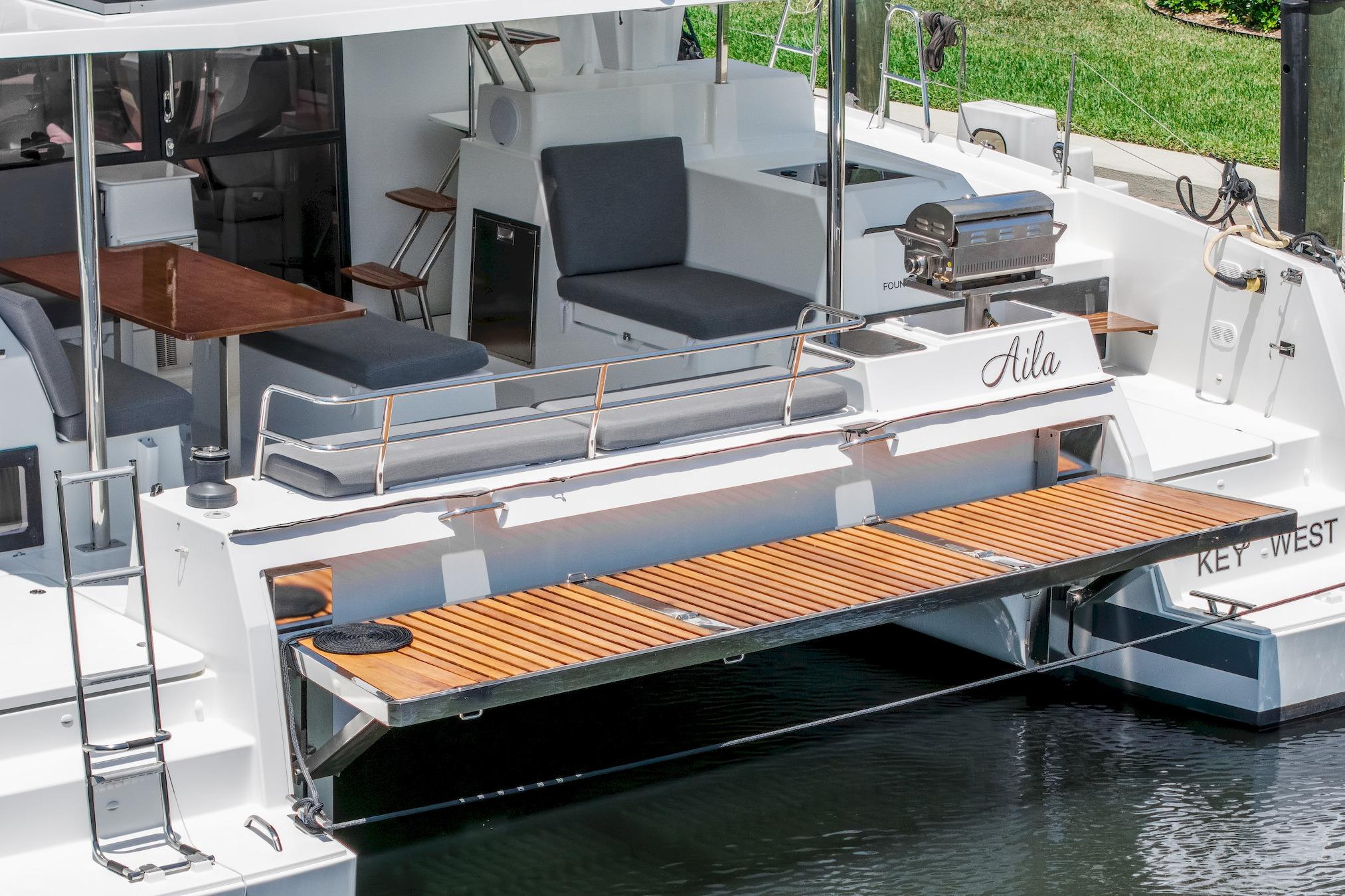 2020 Fountaine Pajot Saona 47 yacht with outdoor seating and grill area.