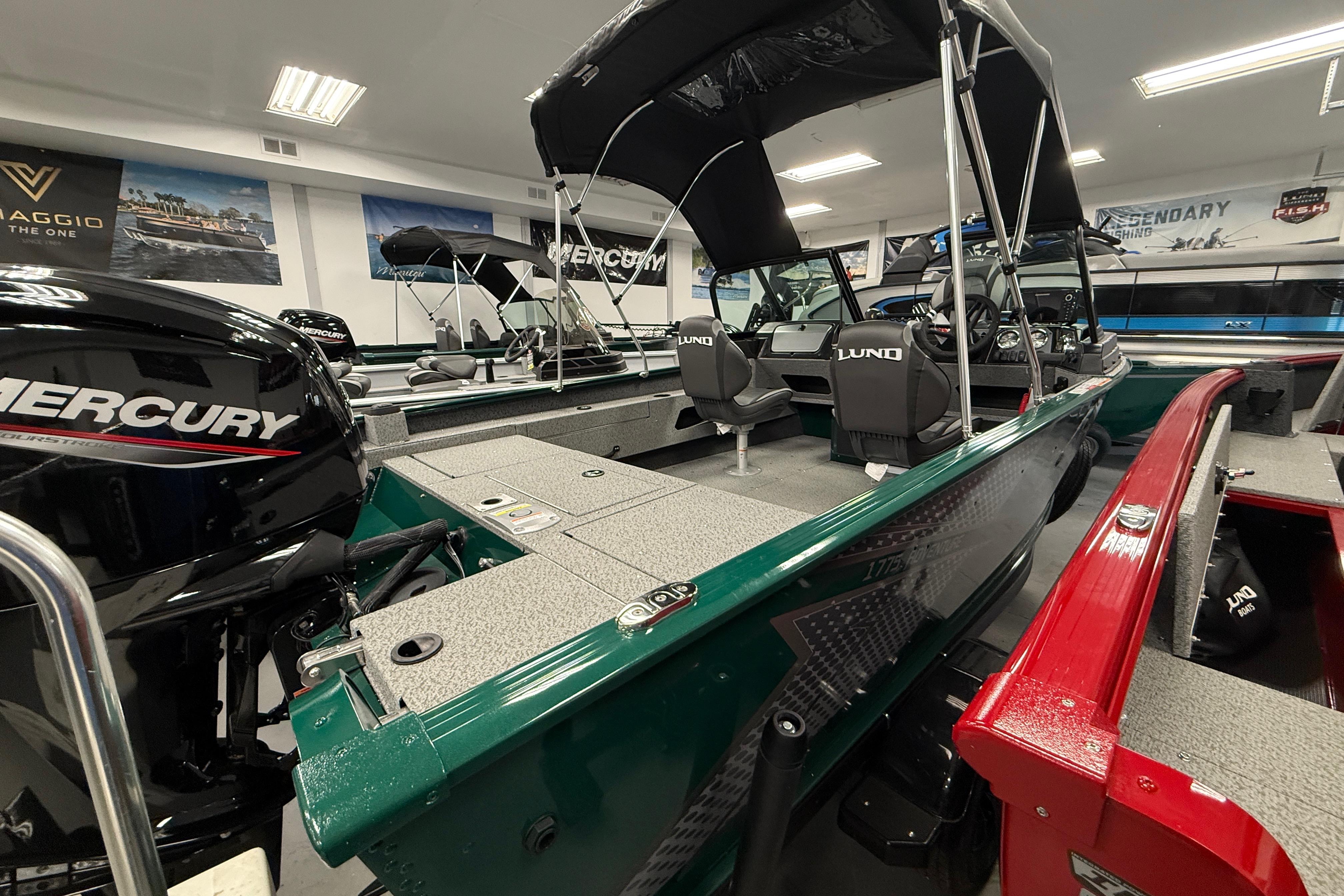 2026 Lund 1775 Adventure Sport boat with Mercury engine in showroom display.