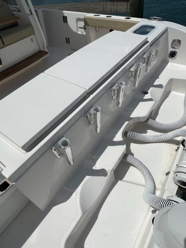 2019 Pursuit S 408 Sport boat deck with rod holders and storage compartments.