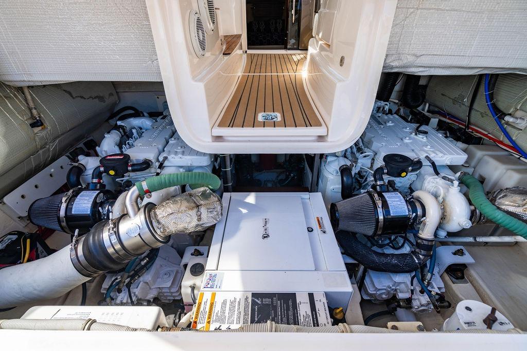 Engine room of 2013 Tiara Yachts 3600 Coronet, showcasing dual engines and equipment.