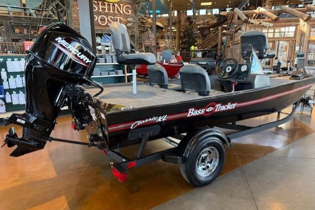 2026 Tracker Bass Tracker Classic XL boat with Mercury engine on display indoors.