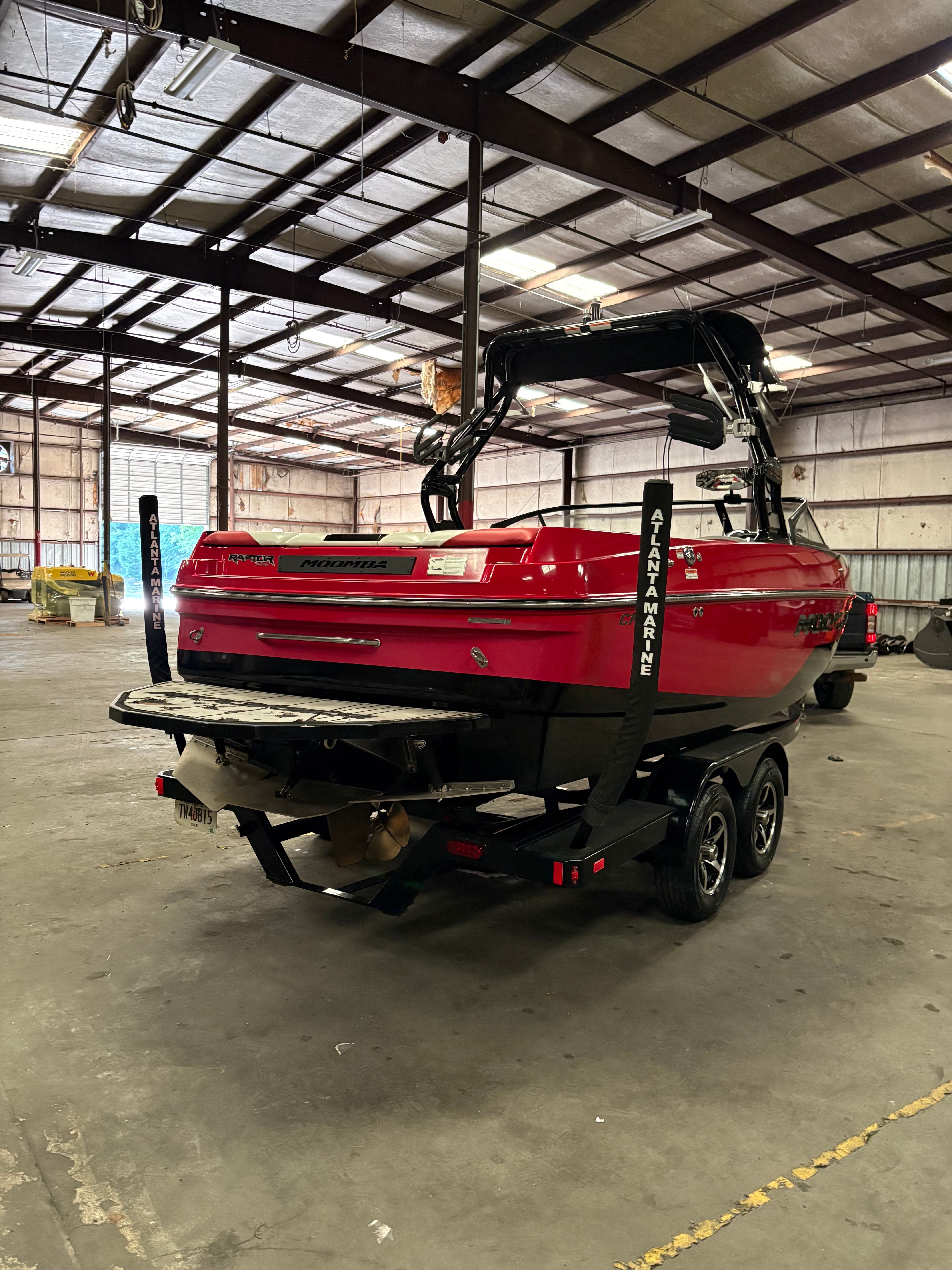 Red 2019 Moomba Craz boat in a warehouse.