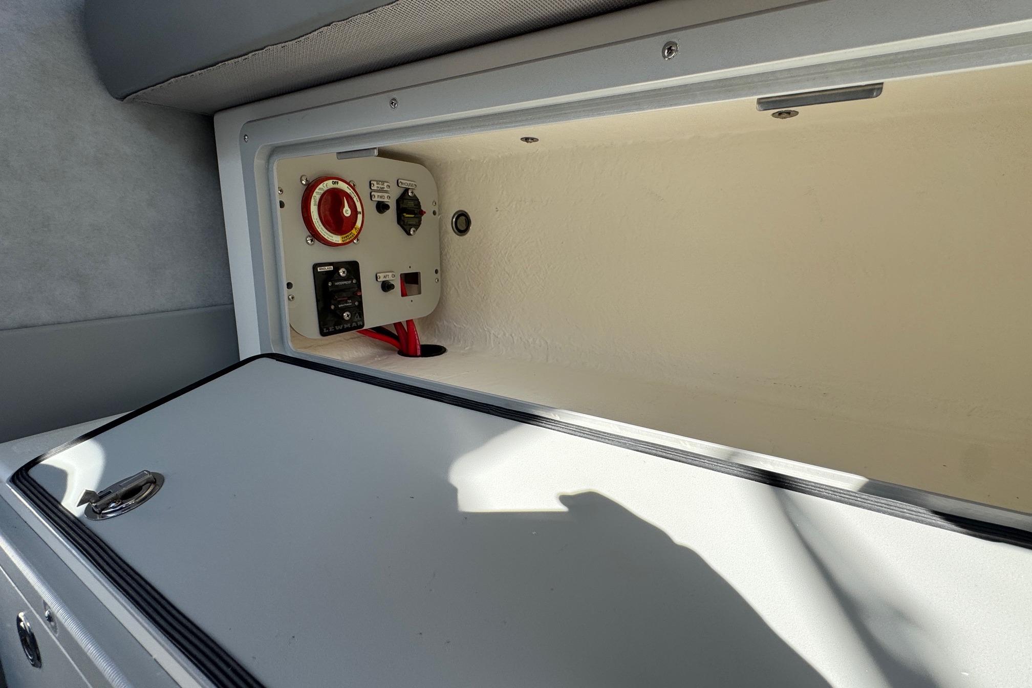 2026 Defiance Admiral 250 EX boat storage compartment with control panel and wiring.