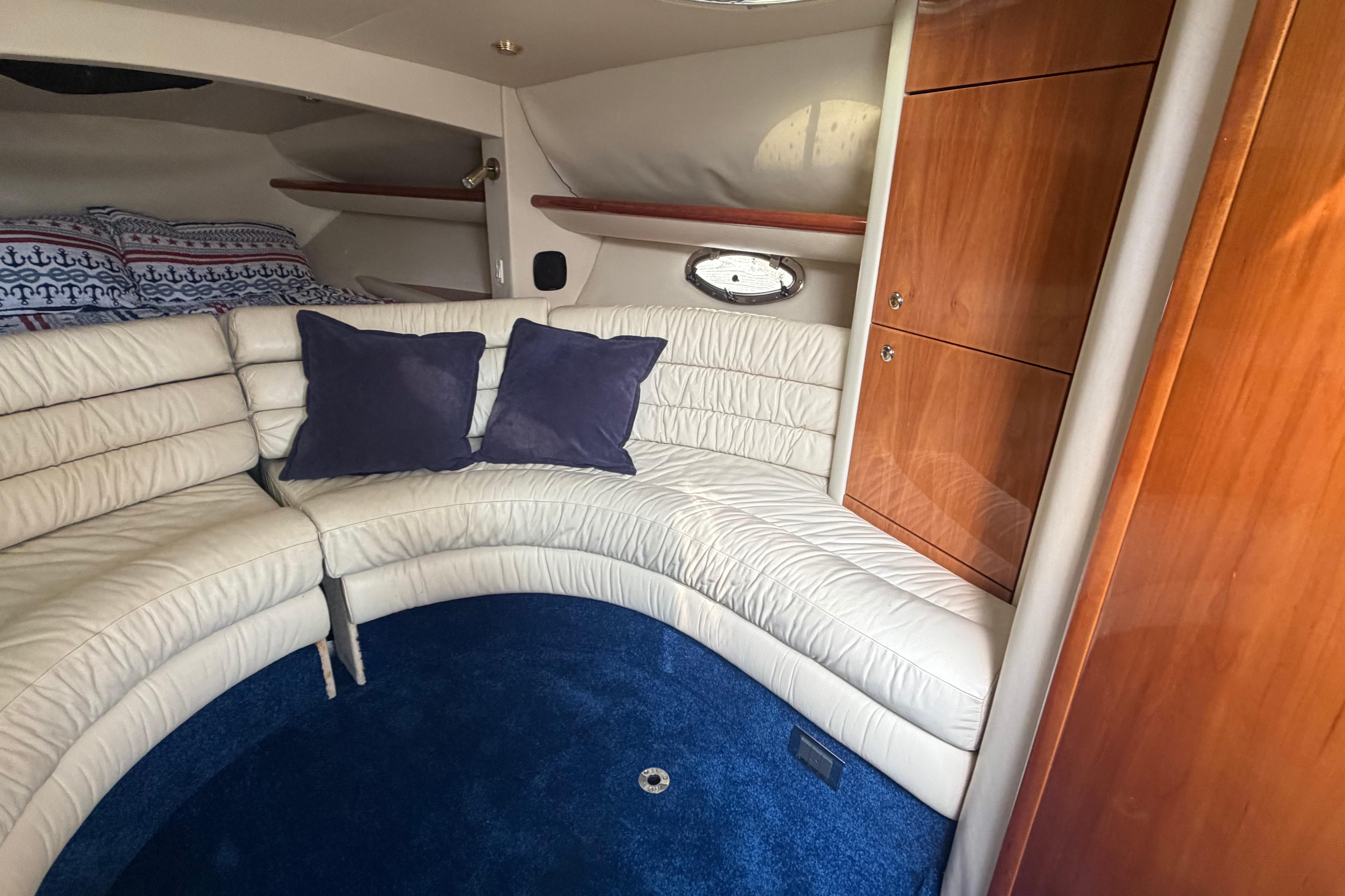 Luxurious interior of 2000 Sunseeker Superhawk 34 with plush seating and elegant wood cabinetry.