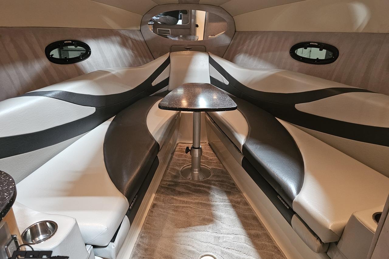 Luxurious interior of a 2008 Baja 335 Performance boat with sleek seating and table.