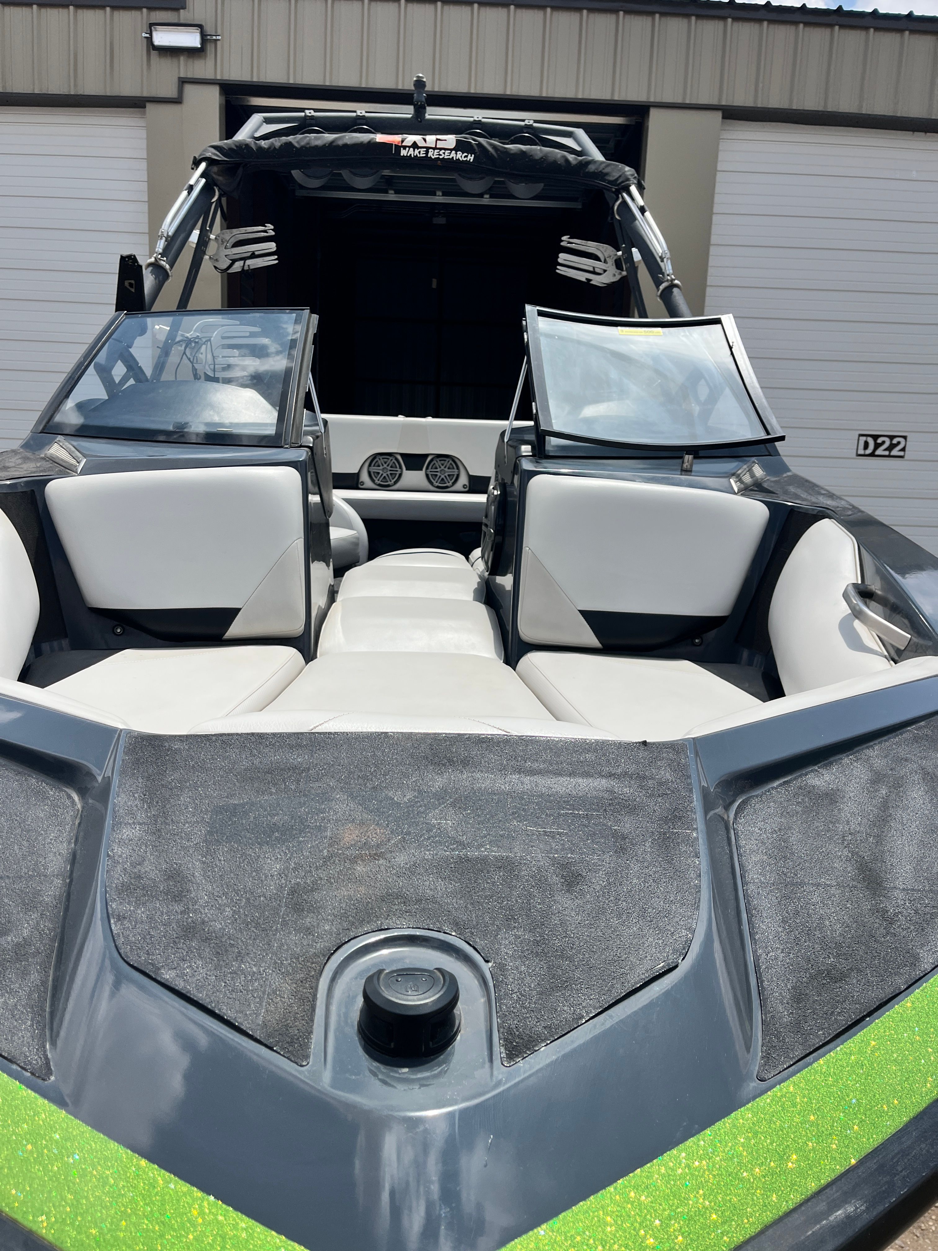 2013 Axis A22 boat with open cockpit and gray seating.