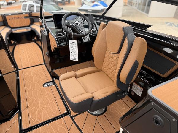 2025 Yamaha Boats 255XD interior with tan seating and modern dashboard.