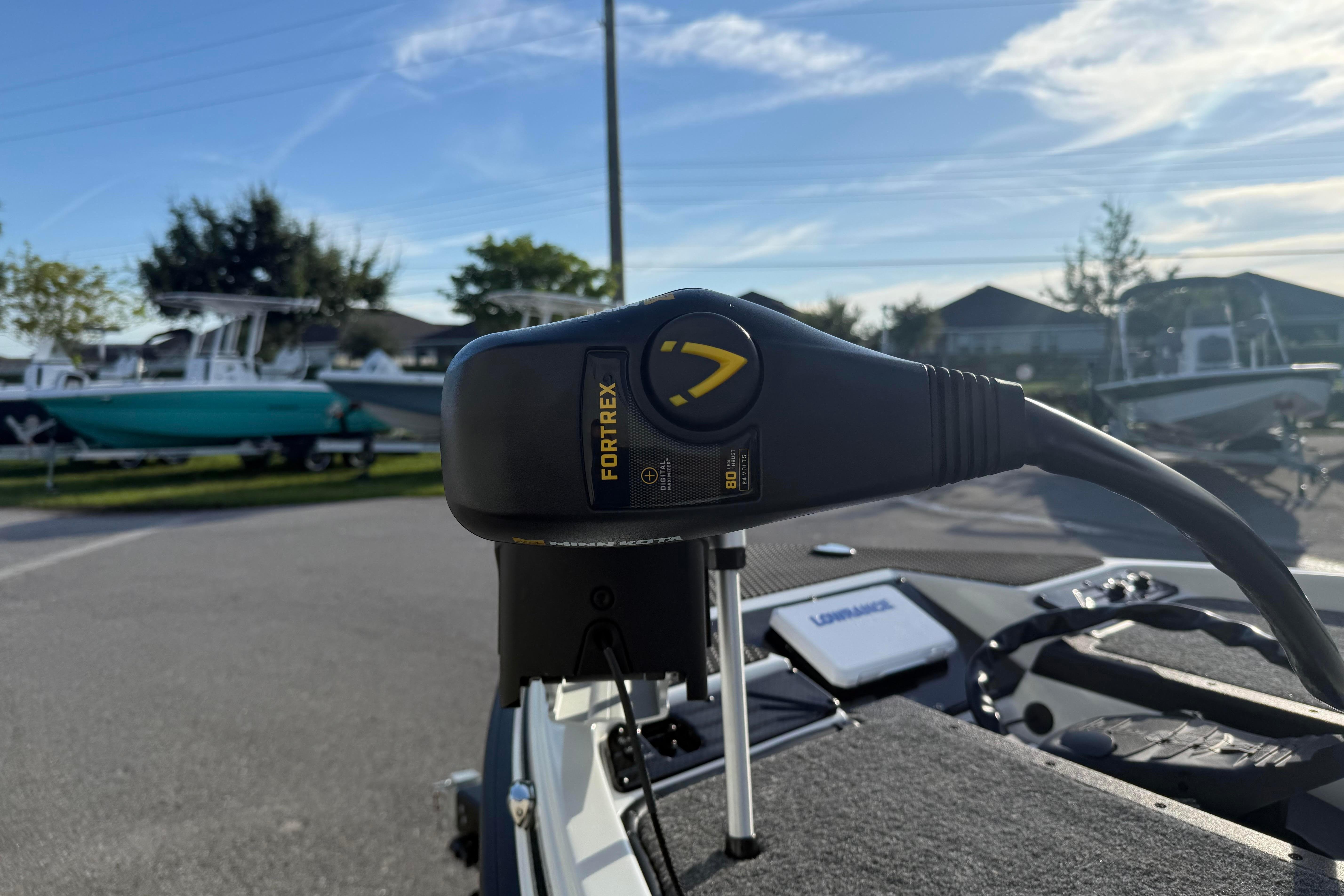 Close-up of Fortrex motor on 2027 Phoenix 721 ZXL boat, with other boats in background.