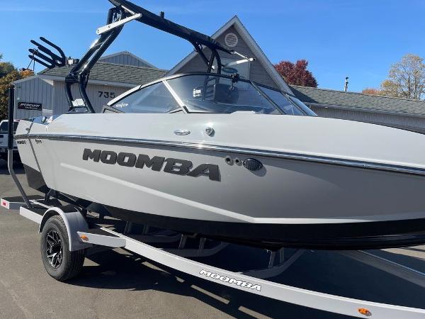 2025 Moomba Mondo boat on trailer, sleek design, parked outdoors.