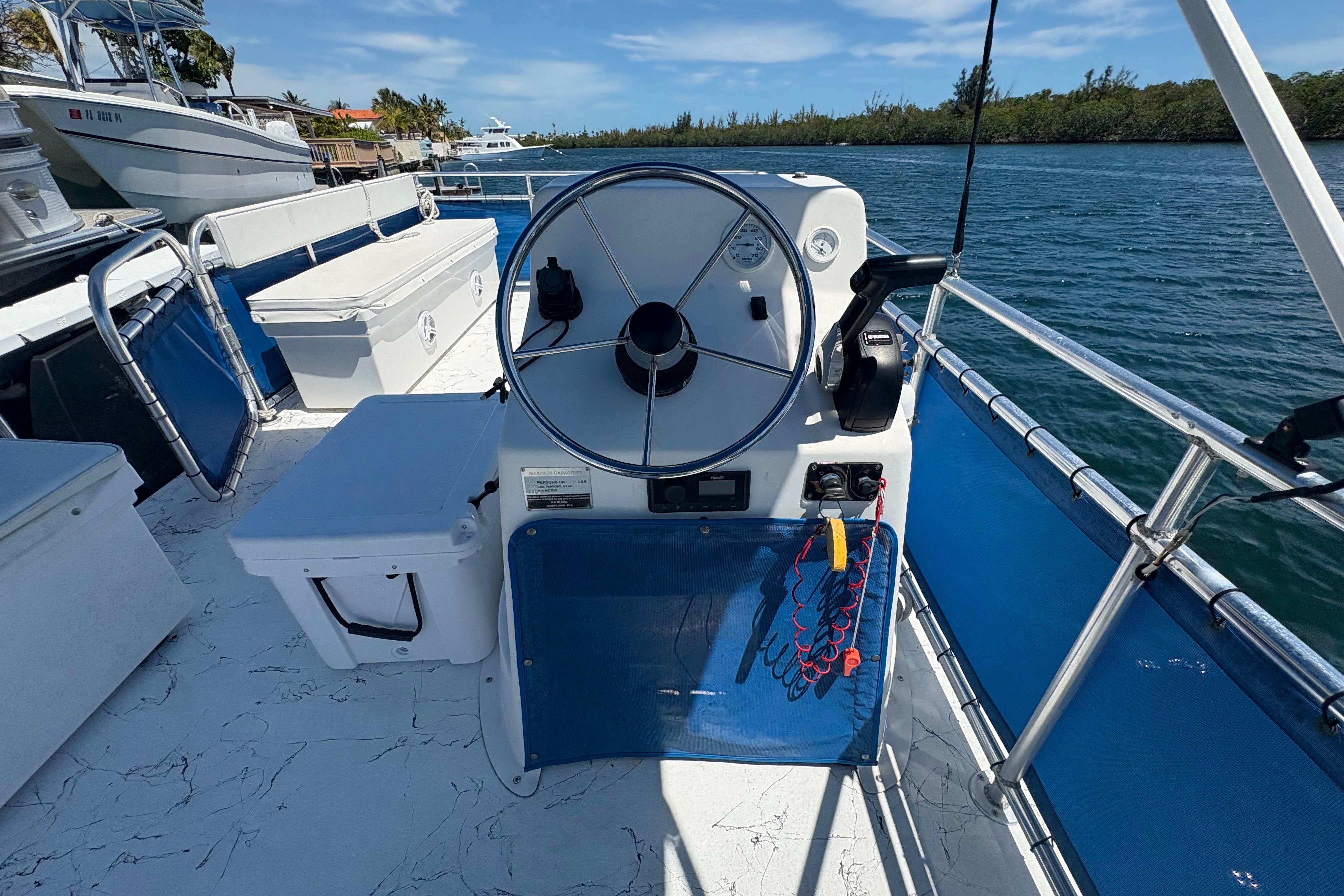 2021 A&M Manufacturing Salty boat helm with steering wheel and controls on a sunny day.