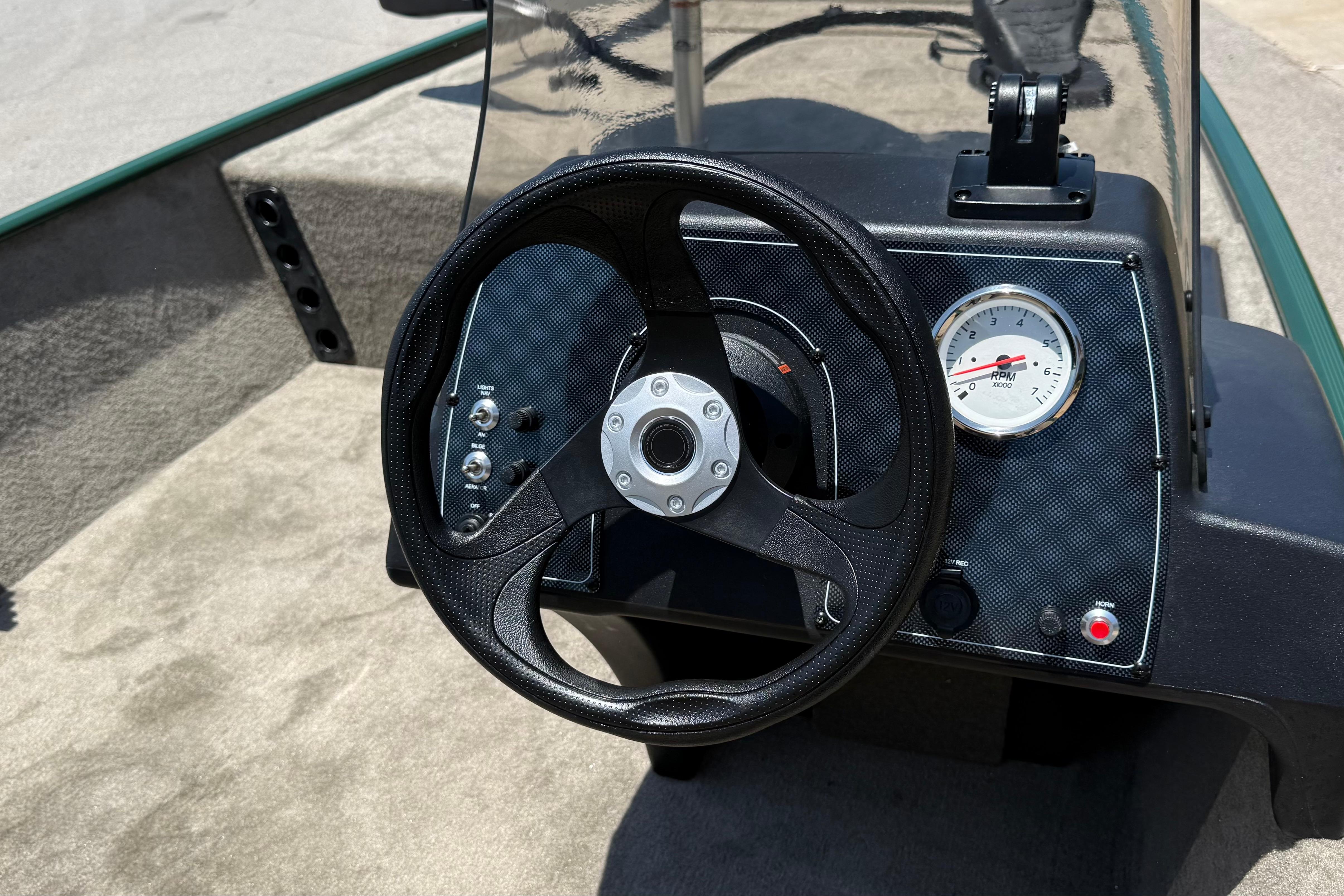 Steering console of 2026 Tracker Bass Tracker Classic Limited boat with RPM gauge.