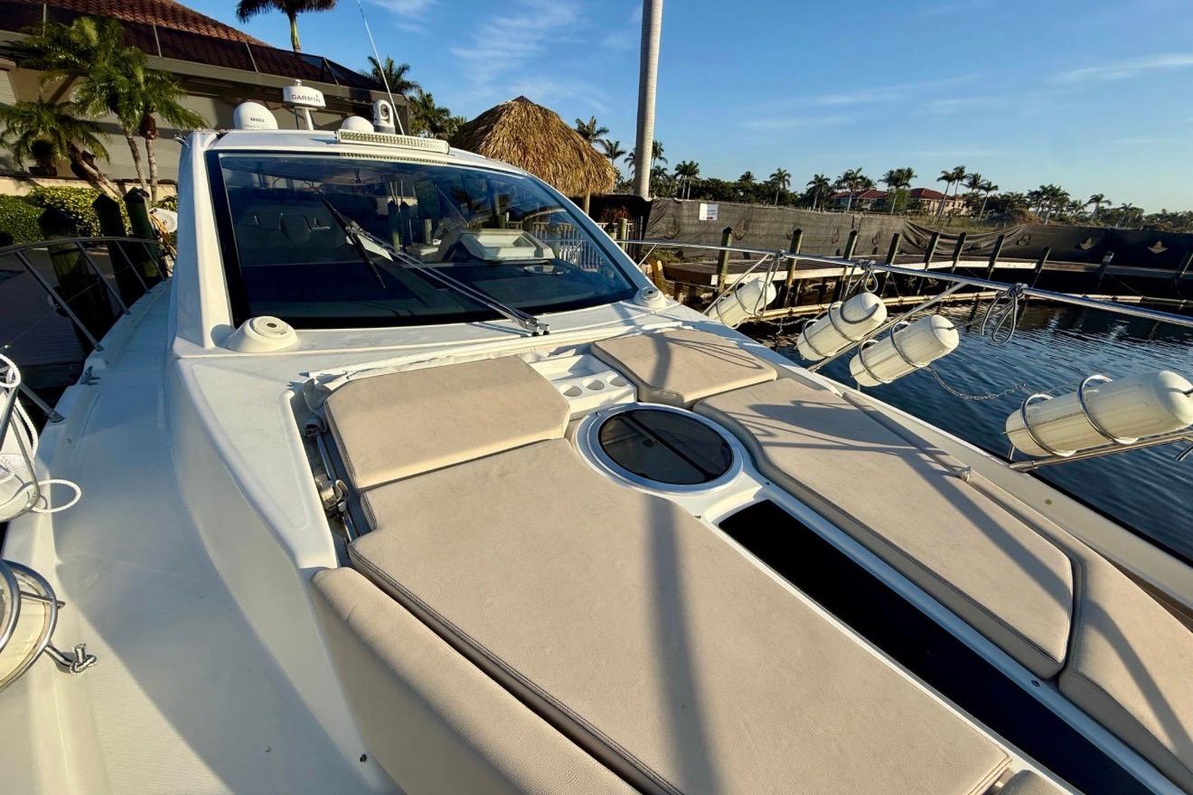 2016 Cranchi M44 HT yacht docked, featuring sleek design and sunbathing area.