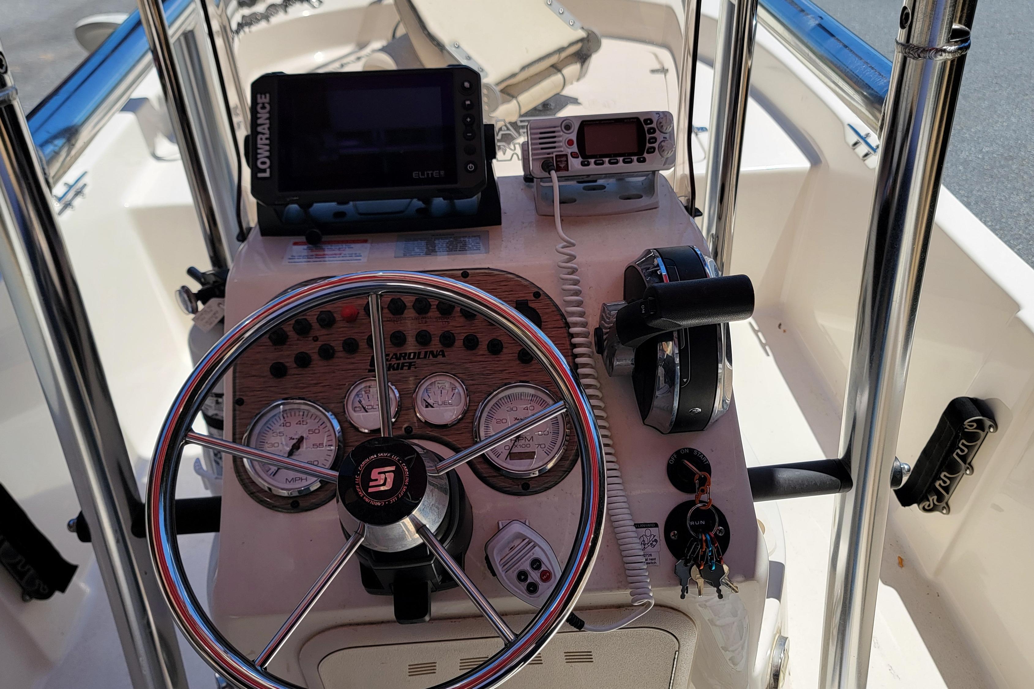 2021 Carolina Skiff 178 JLS boat console with steering wheel and navigation equipment.