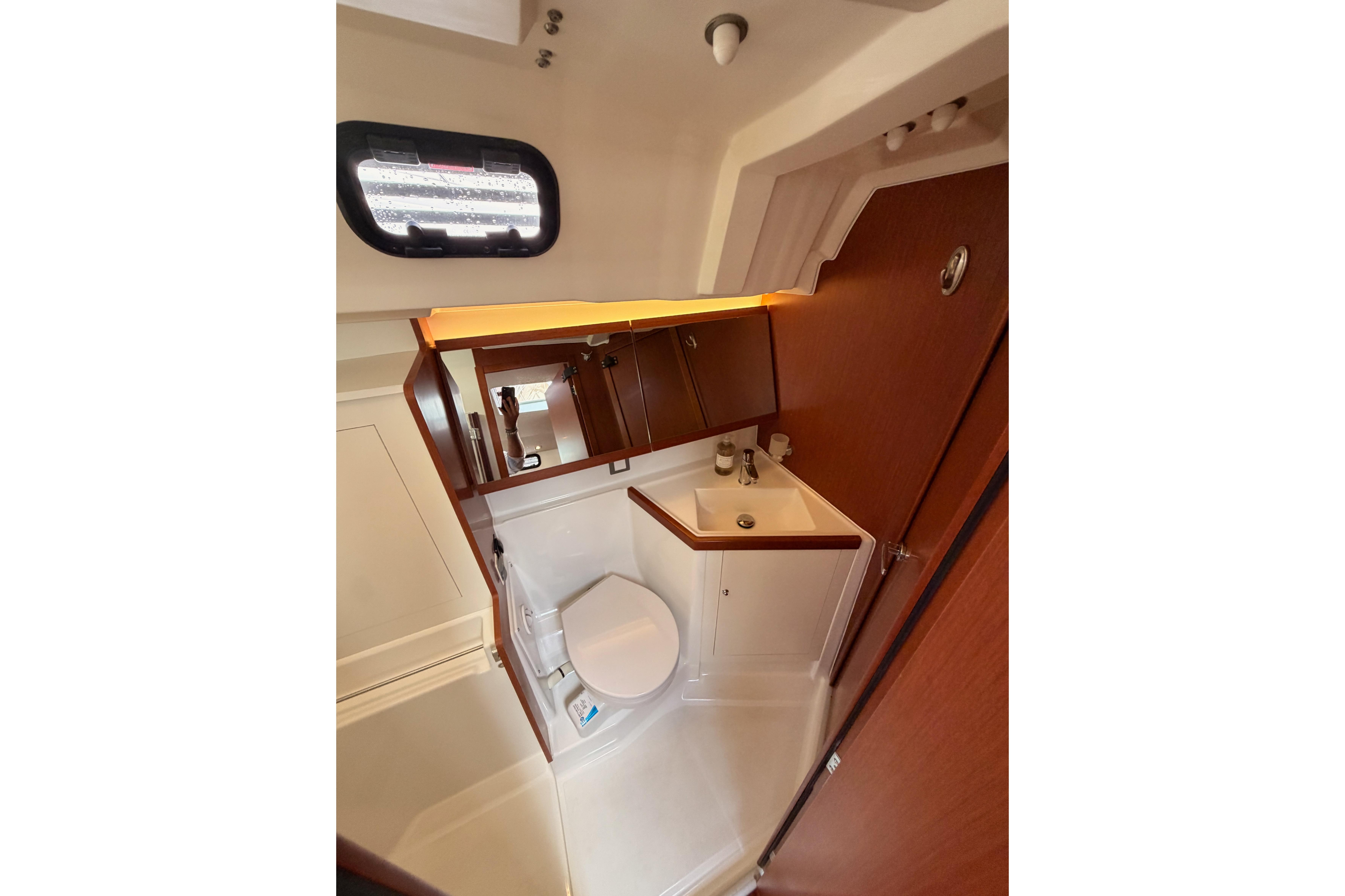 Interior of 2020 Beneteau Oceanis 46.1 yacht bathroom with sink and toilet.