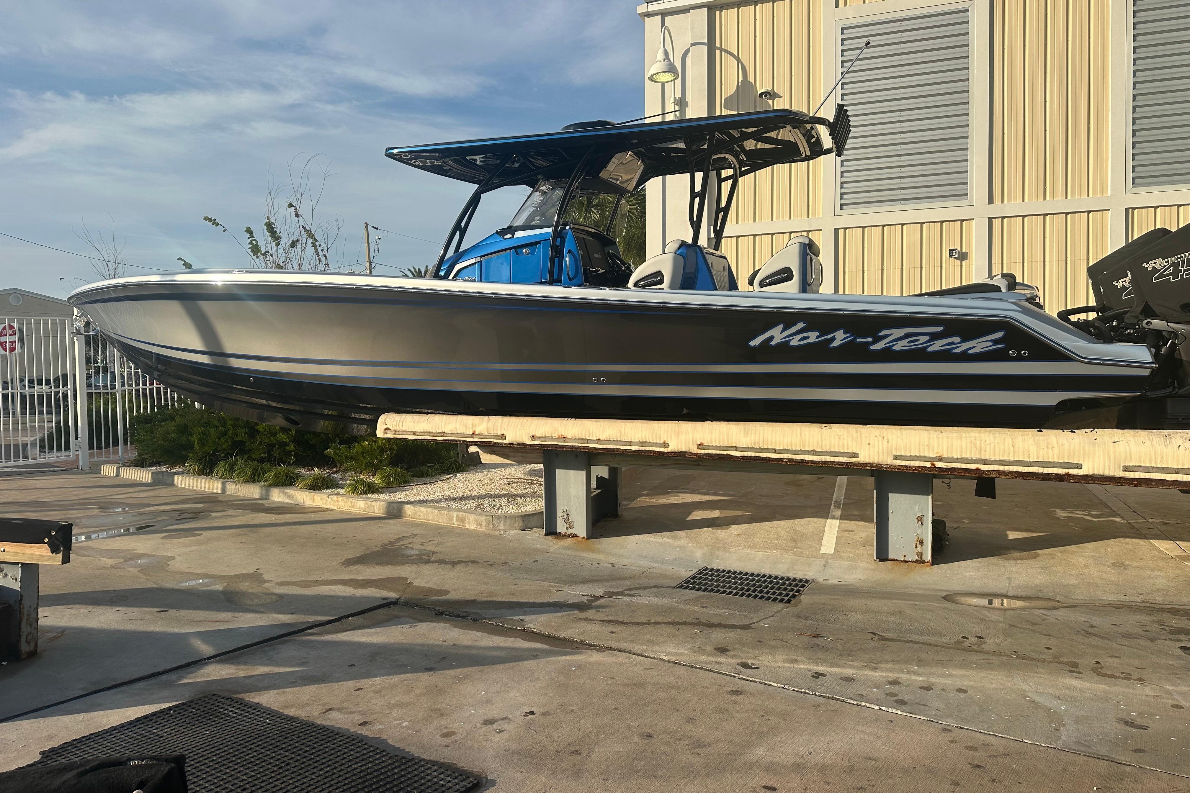 2022 Nor-Tech 390 Sport Center Console boat on display at a marina.