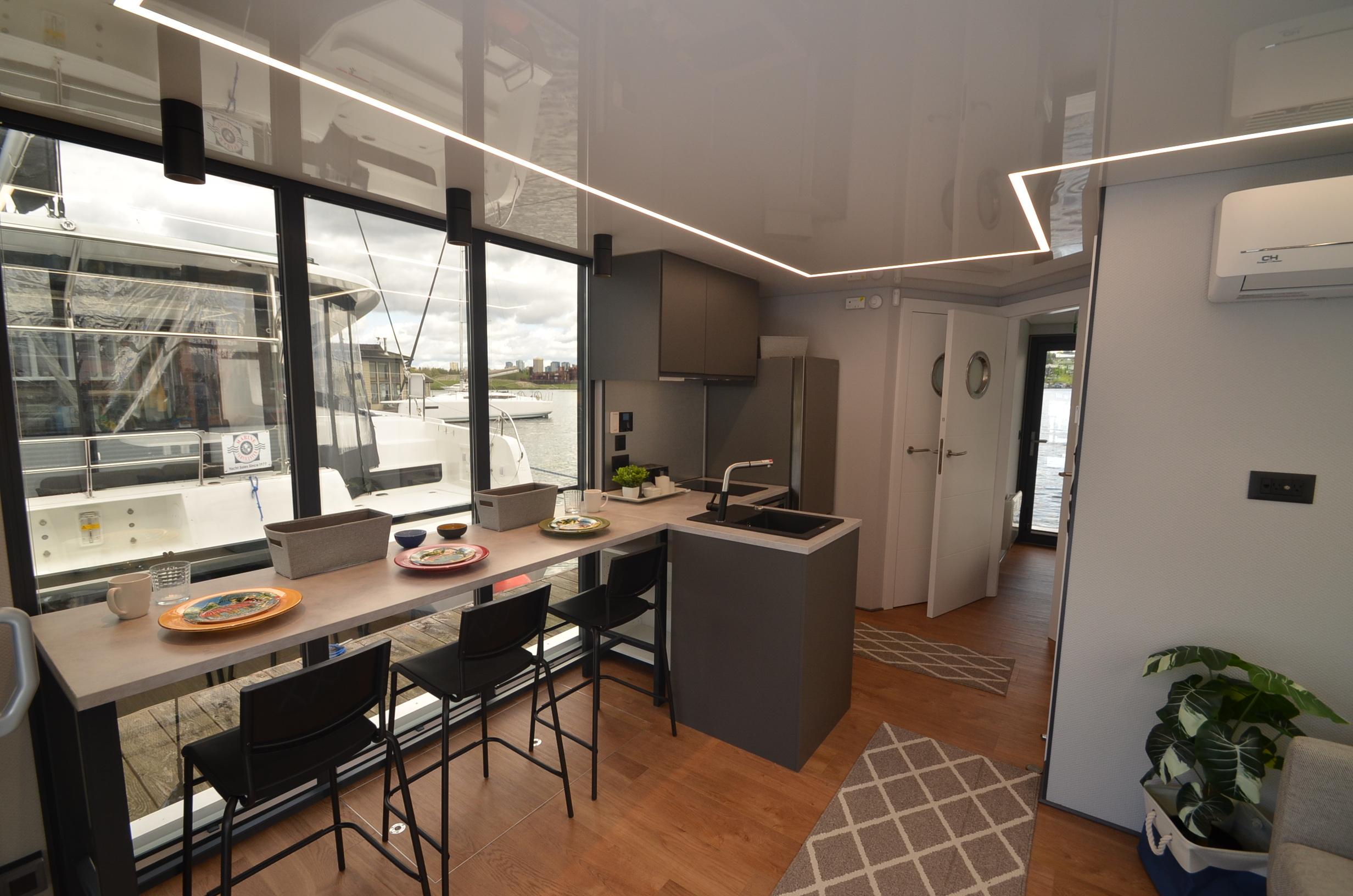 Modern kitchen interior of La Mare Modern 11 houseboat, 2024 model, with sleek design and waterfront view.