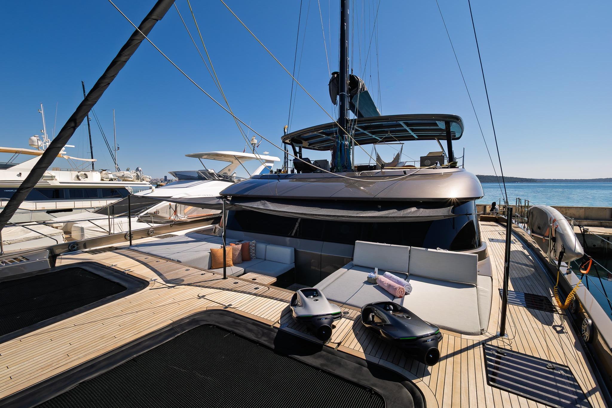 Luxurious 2025 Sunreef 60 yacht docked, showcasing sleek design and spacious deck.