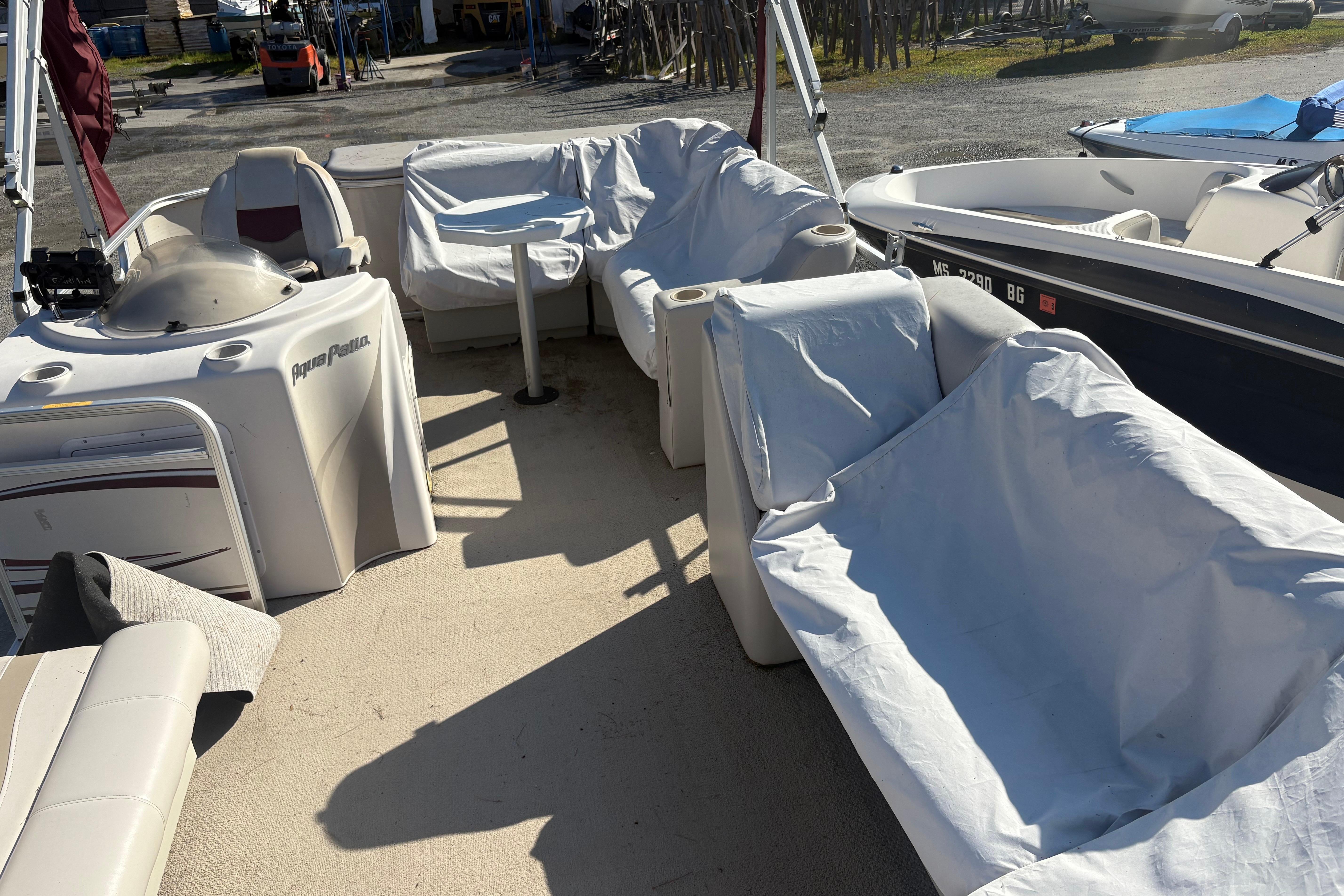 2003 Aqua Patio 200RE pontoon boat interior with covered seating and helm.
