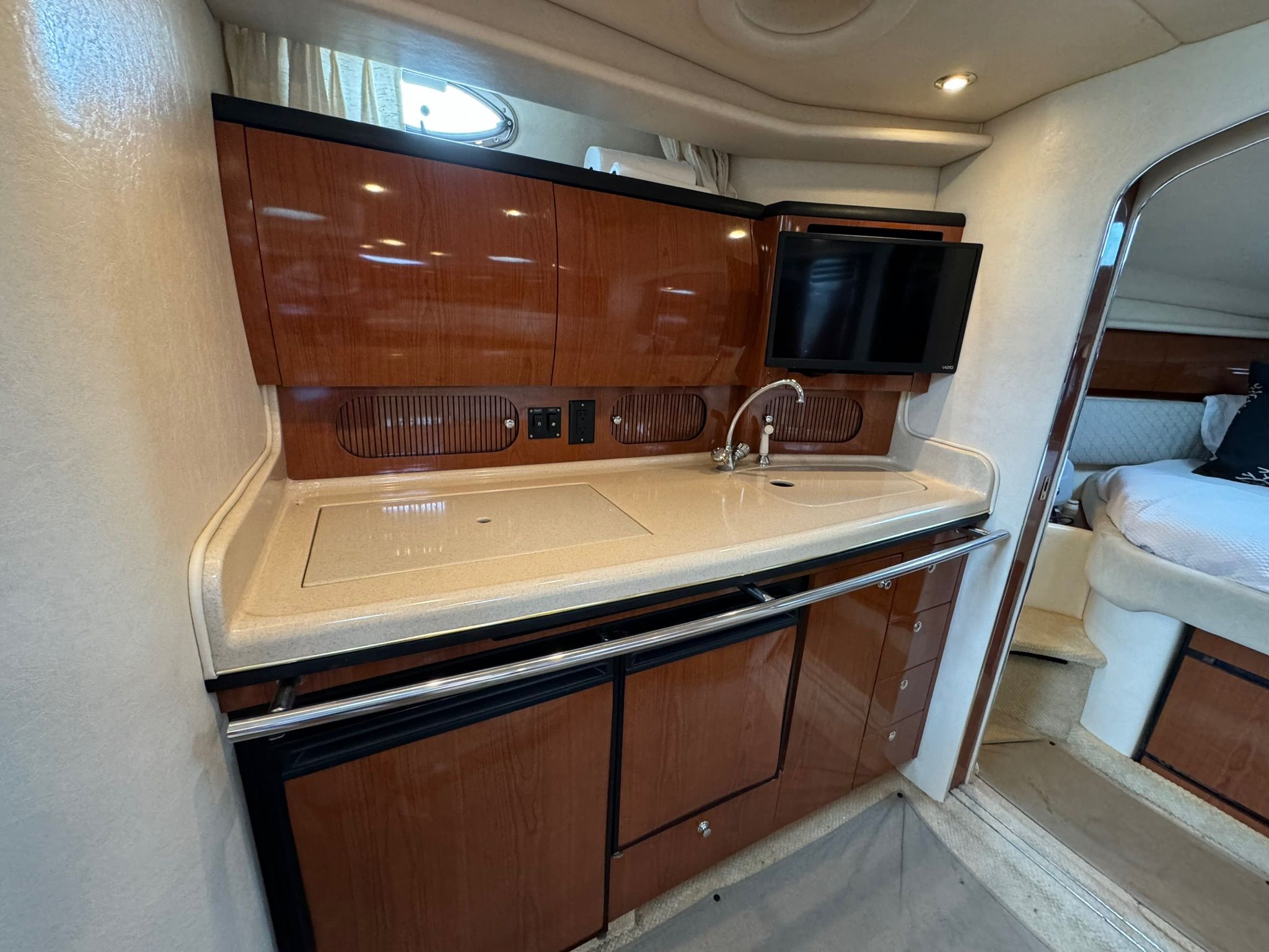 Interior of 2002 Sea Ray 360 Sundancer with kitchenette and sleeping area.