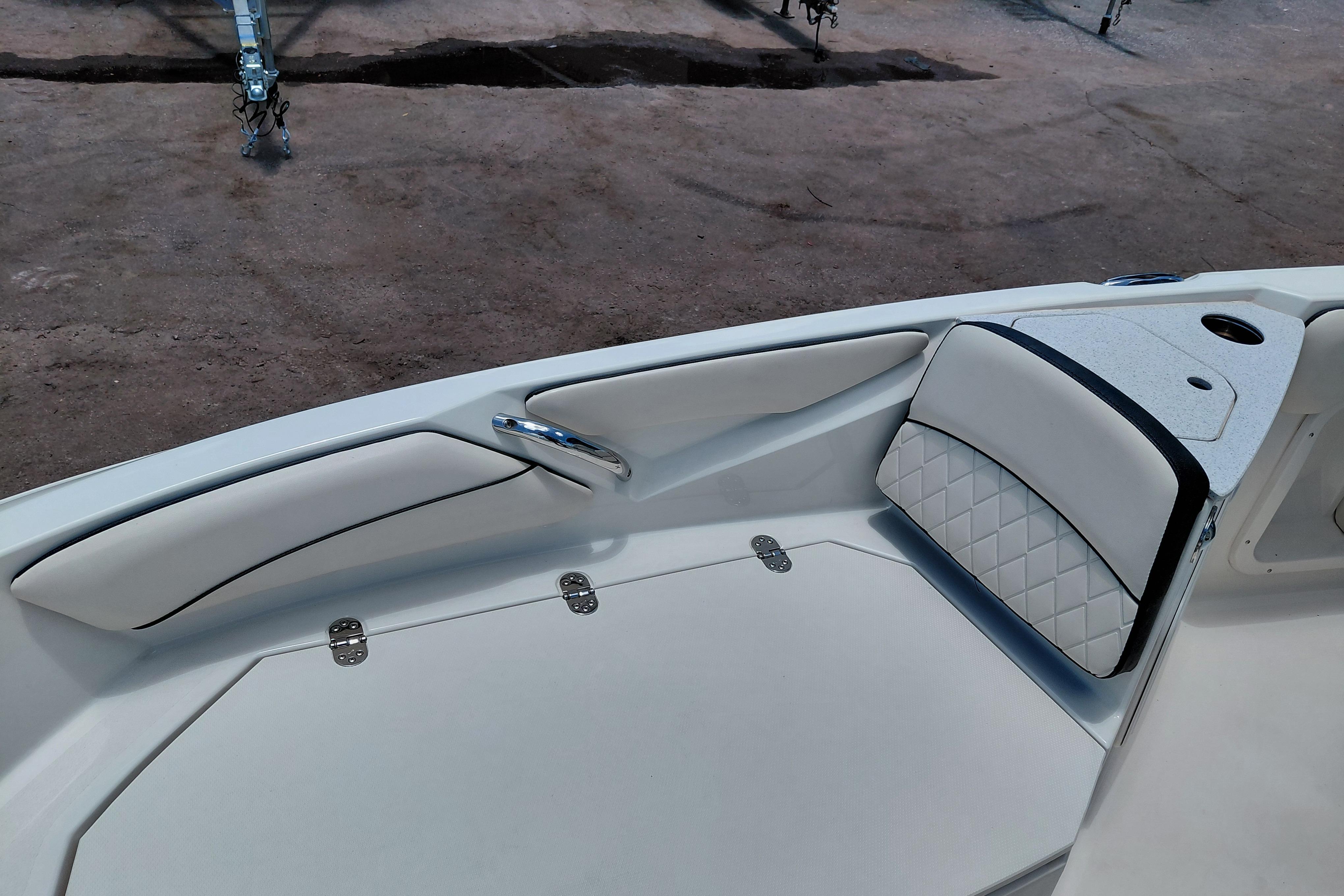 2023 Stingray 206 CC boat interior with white cushioned seating and stainless steel handle.