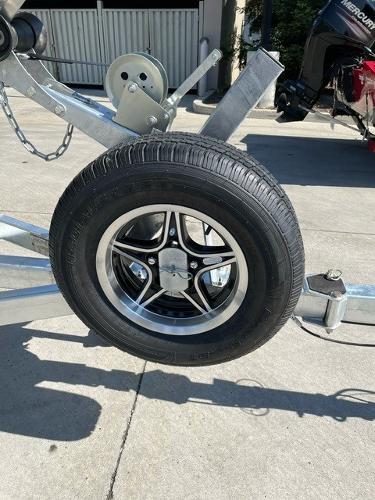 Trailer wheel of 2025 Spartan 185 Astoria, featuring sleek black and silver design.