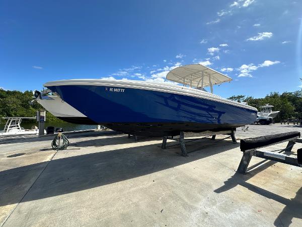 2005 Intrepid 323 boat on trailer under clear blue sky.