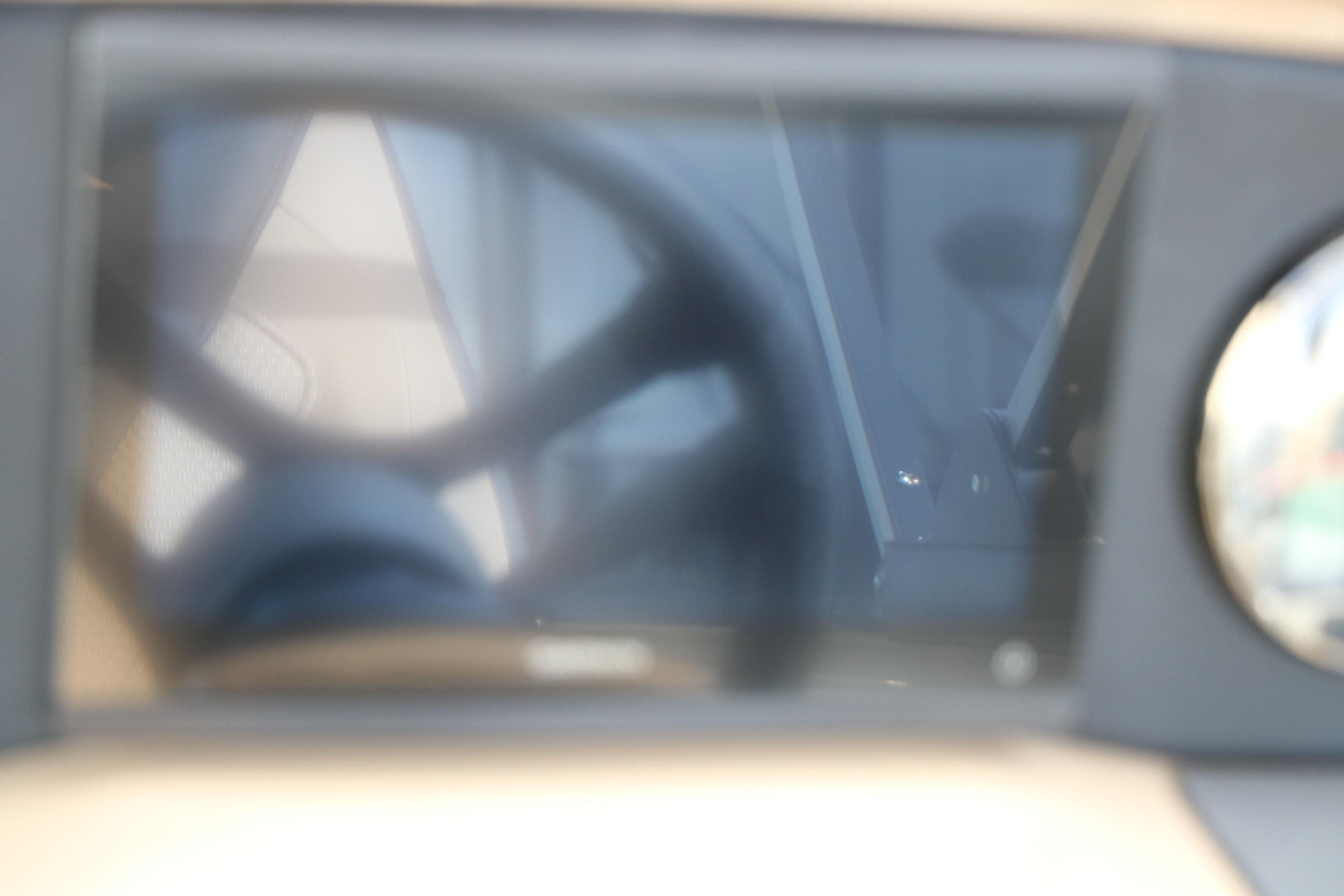 Blurry interior view of 2026 Evotti 523CS dashboard and steering wheel.