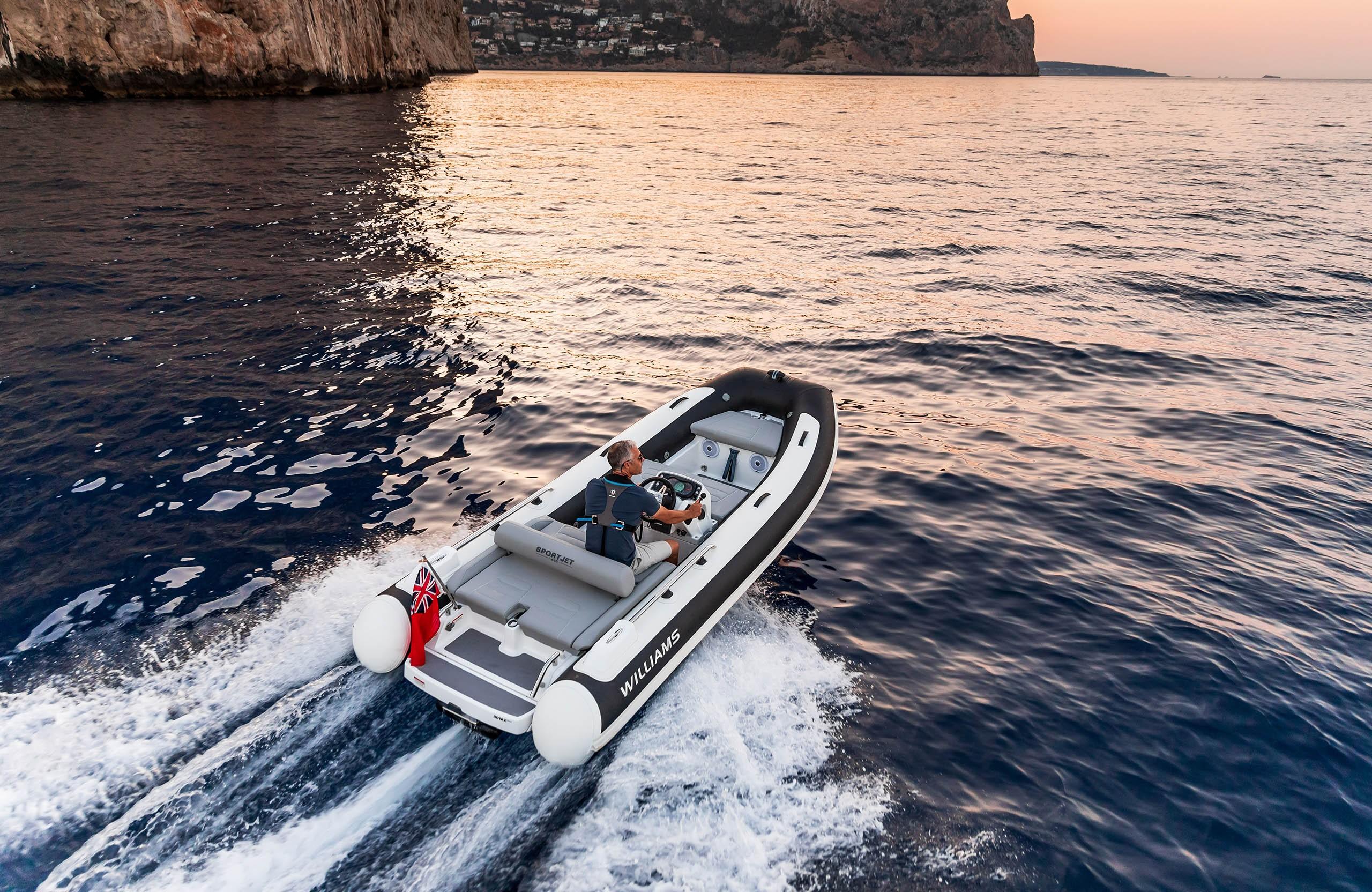 2025 Williams Jet Tenders Sportjet 435 cruising on open water at sunset.