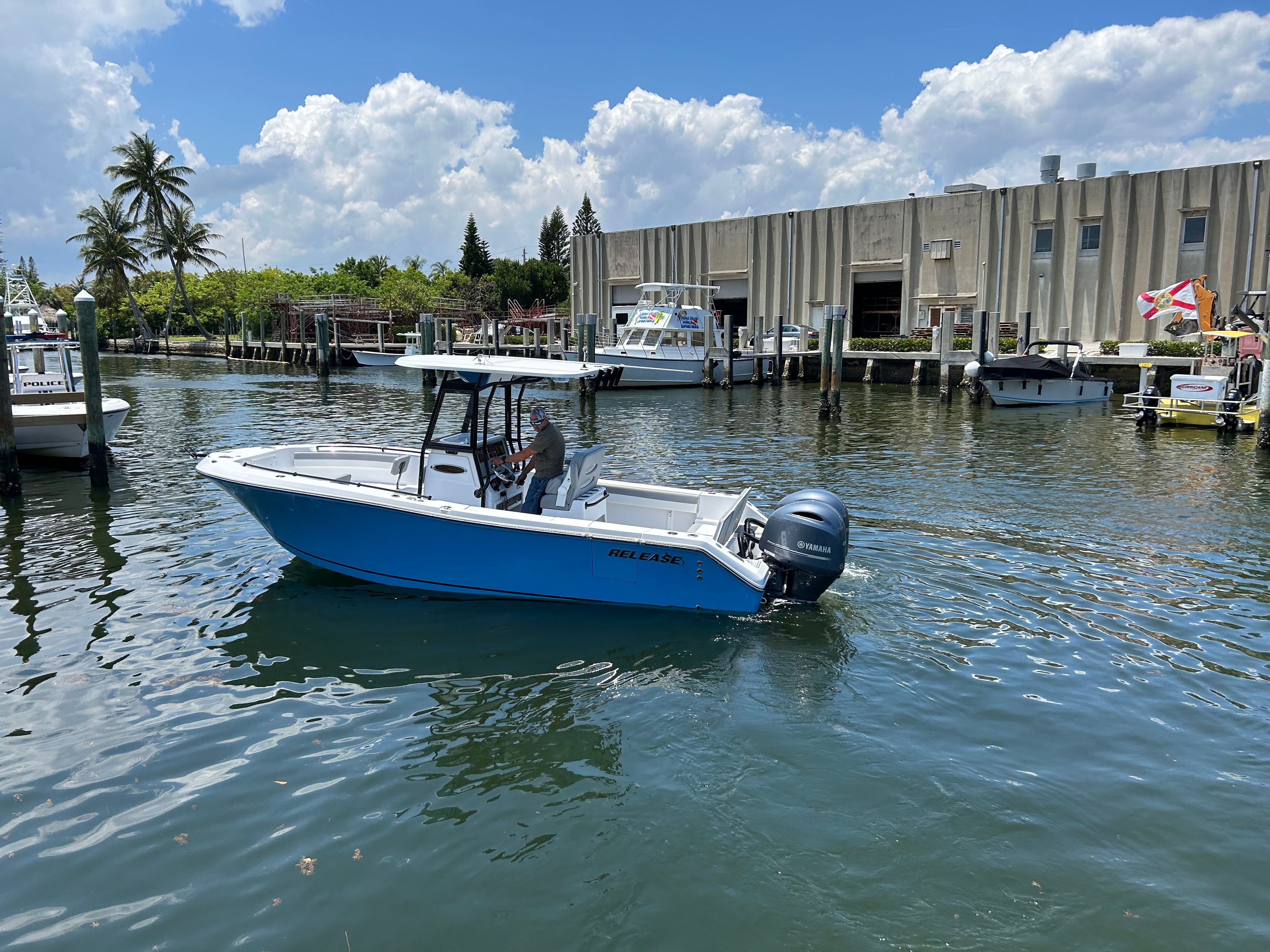 Release 240 RX 2022 boat on water near building.
