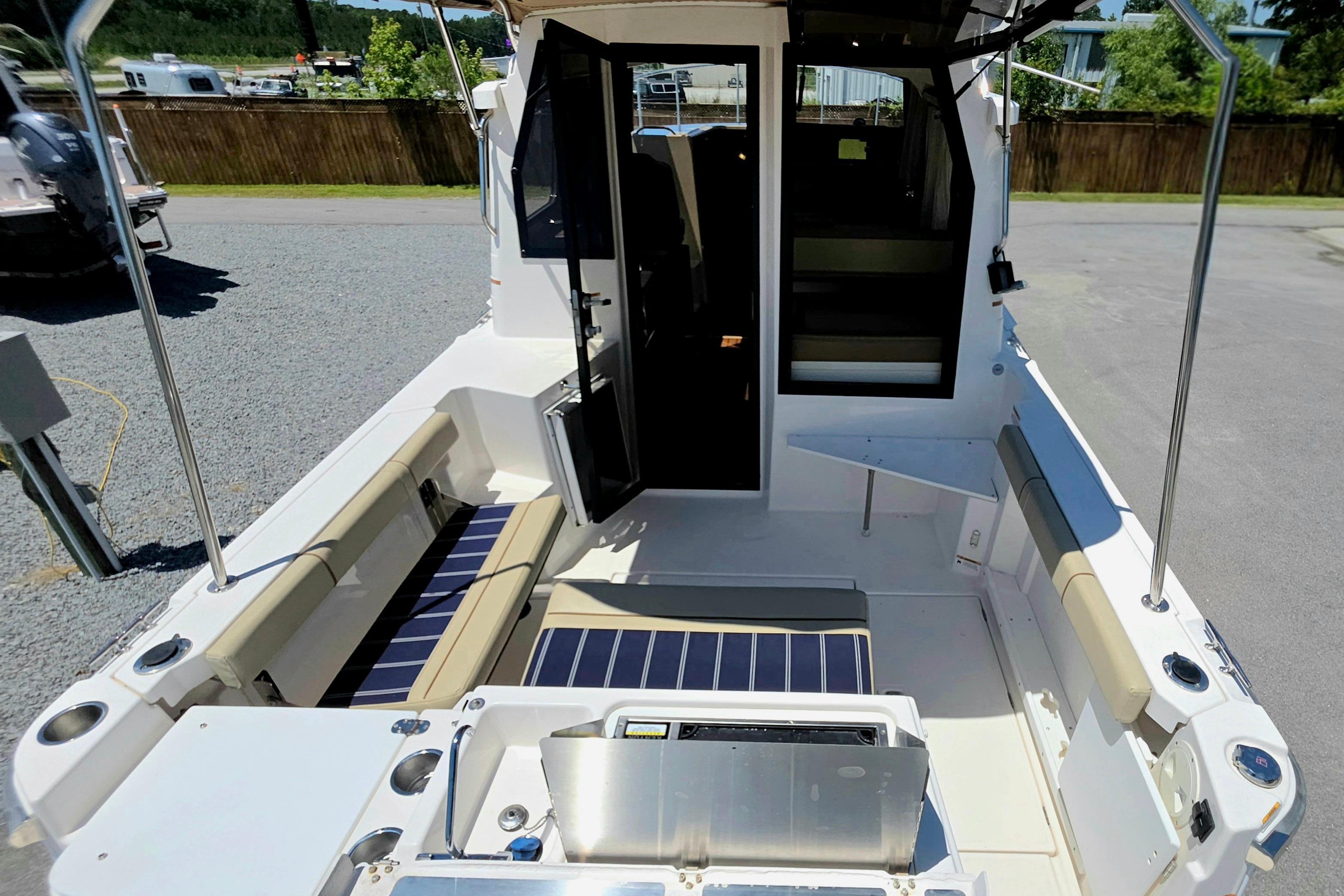 2021 Ranger Tug R27 boat interior with seating and open cabin door.