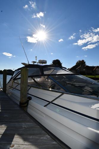 1997 Sunseeker Camargue 47 yacht docked under a bright sunlit sky.
