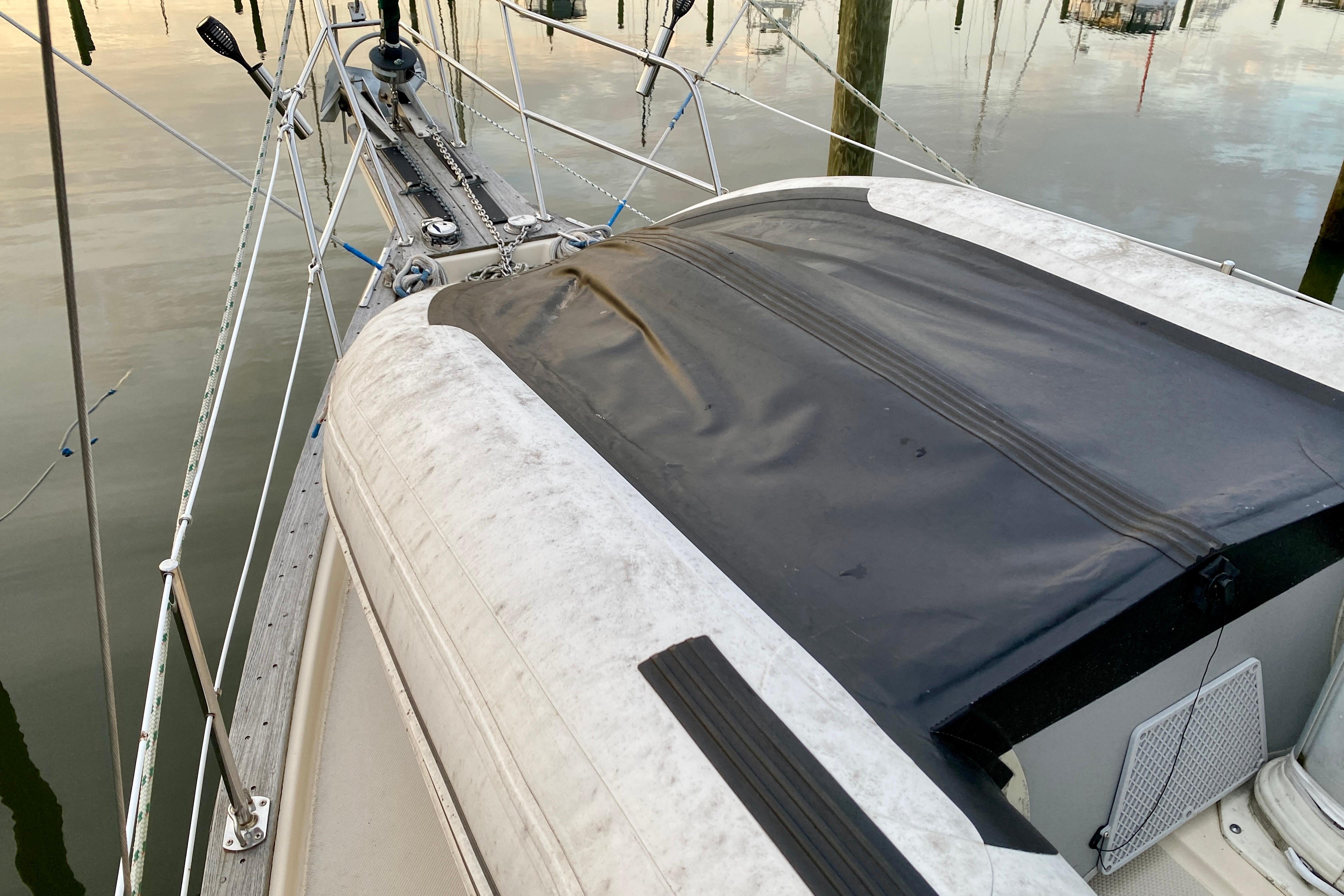 Sailboat deck of 1992 Island Packet 29 with black cover and rigging details.