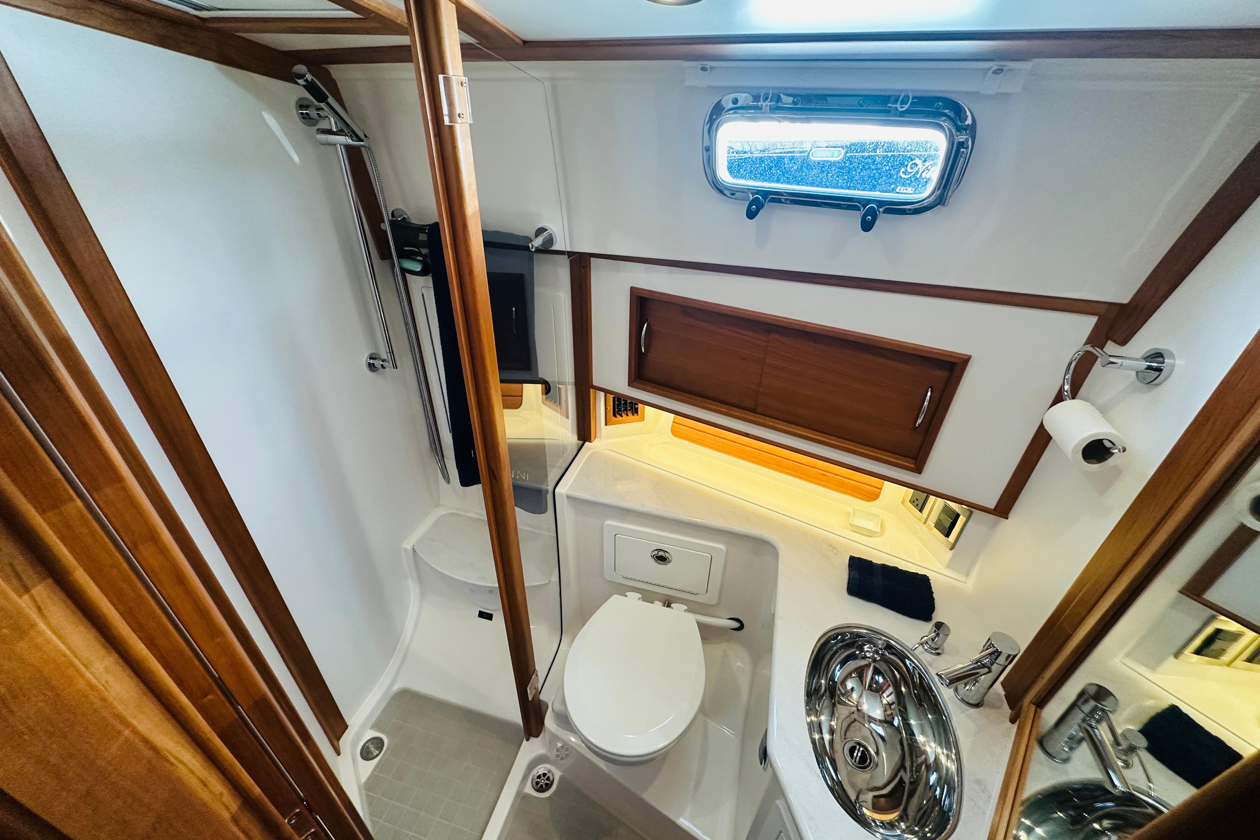 Luxurious bathroom in 2025 Sabre 48 Salon Express yacht, featuring modern fixtures and wood accents.