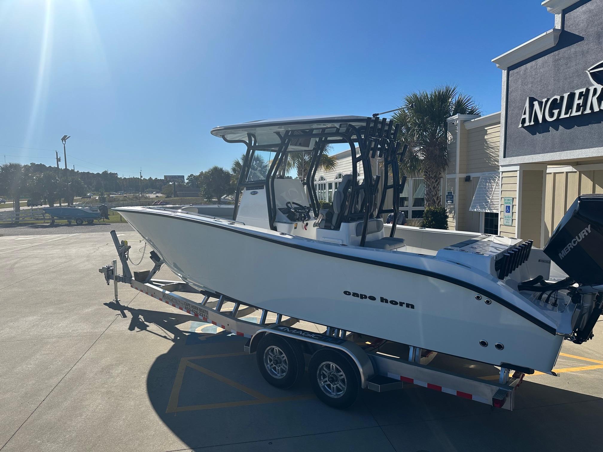 2025 Cape Horn 28XS boat on trailer, parked outside Angler's store under clear blue sky.