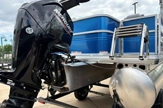 2026 Sun Tracker Party Barge 18 DLX with Mercury outboard motor, docked and ready for adventure.