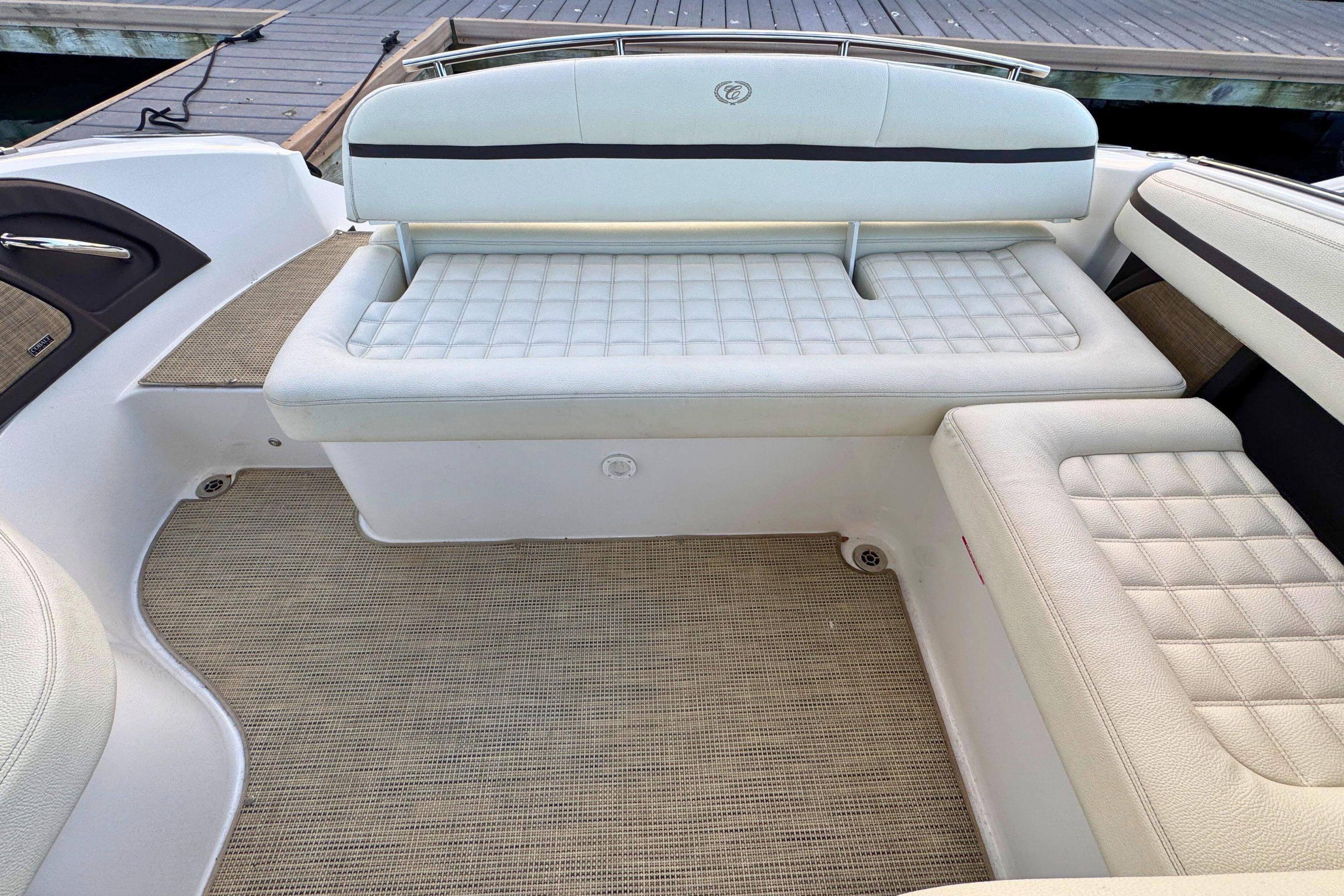 2019 Cobalt R3 boat interior with white cushioned seating and beige flooring.