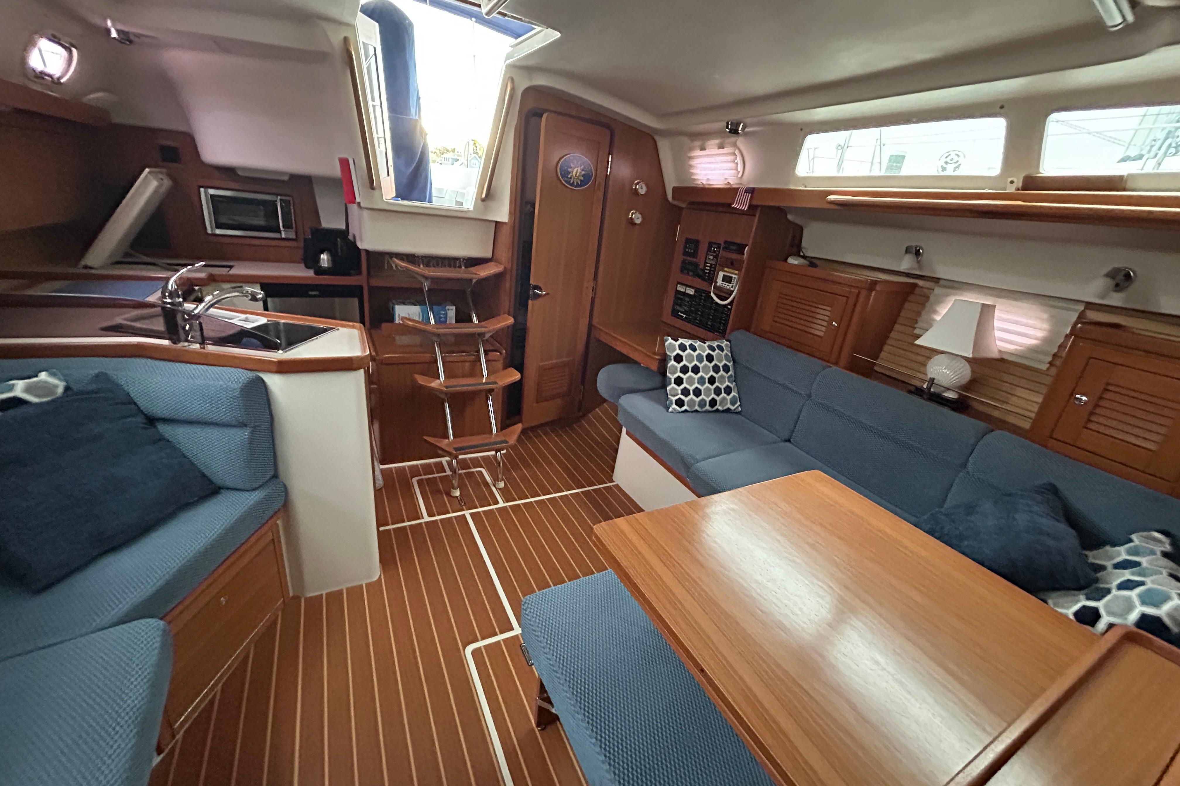 Interior of a 2009 Catalina 375 sailboat with cozy seating and wooden finishes.